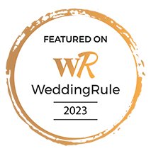 A circular gold and white WeddingRule featured vendor badge for 2023 displayed on black background.