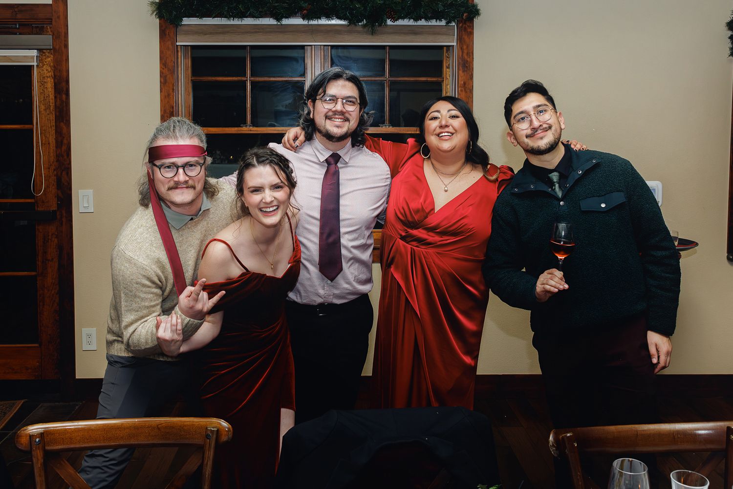 Group of people posing together in casual attire at what appears to be a social gathering or event.
