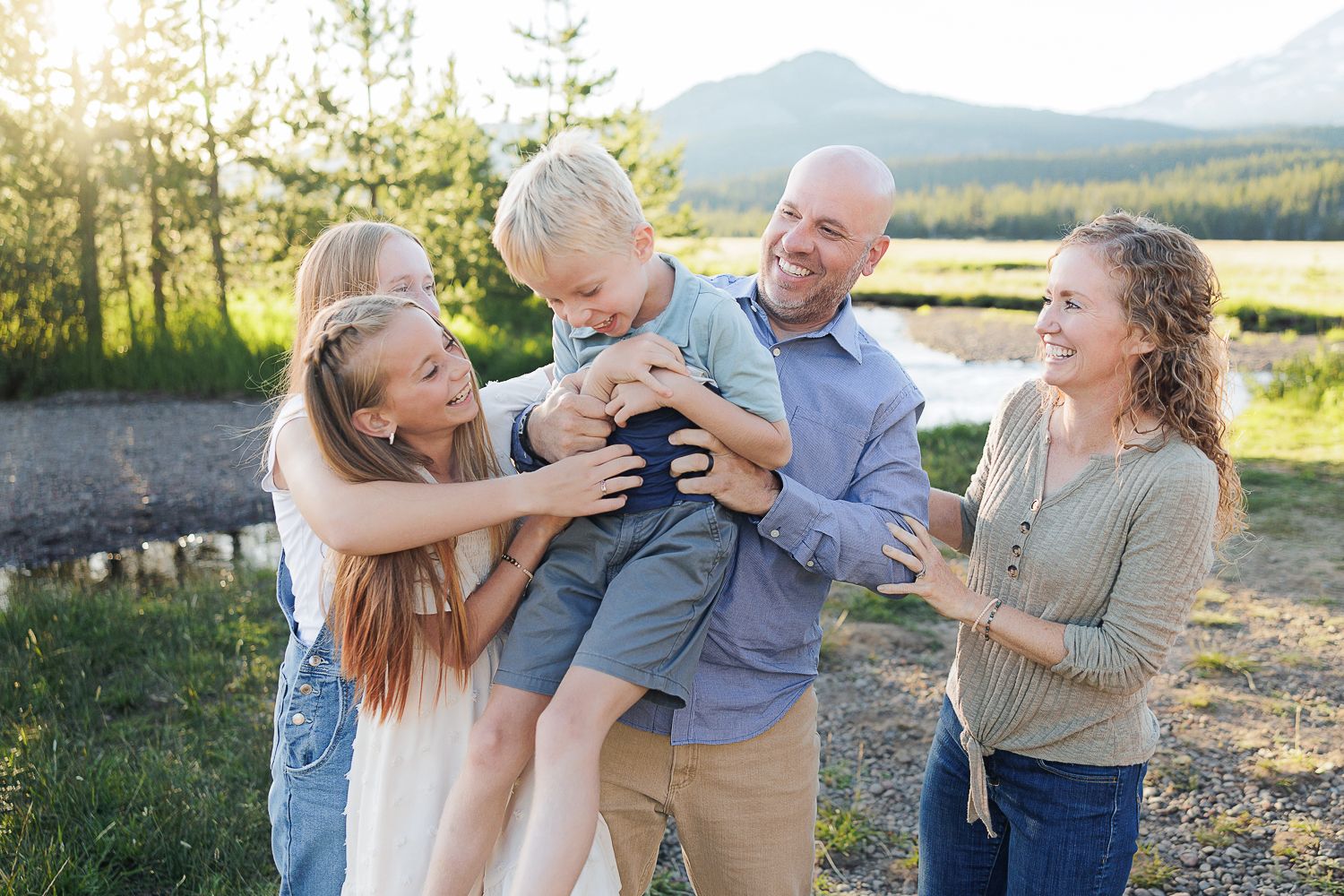 A series of candid family photographs capturing joyful moments and laughter together outdoors during golden hour.