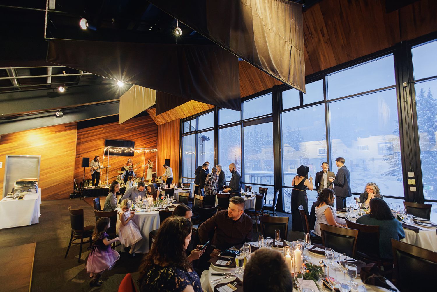 Business professionals gathered in a modern conference room with floor-to-ceiling windows for a corporate meeting.