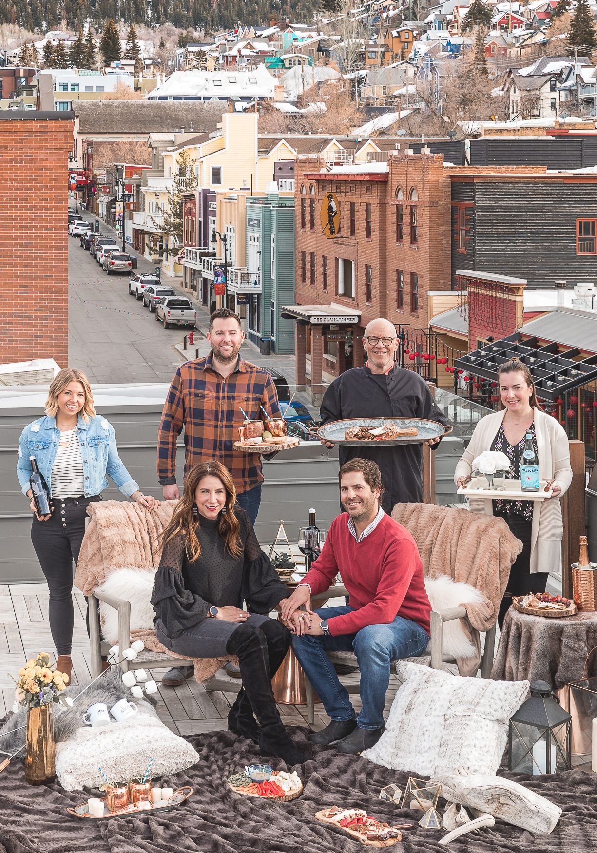 Rooftop gathering with historic mountain town buildings and streets in background.