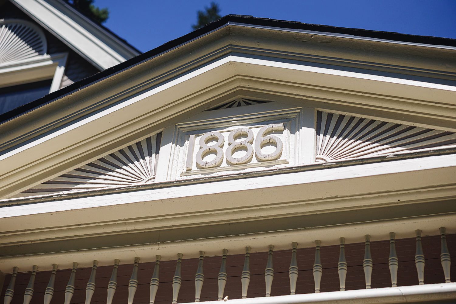Up-close architectural detail shows a decorative sunburst pediment design above house numbers 336.