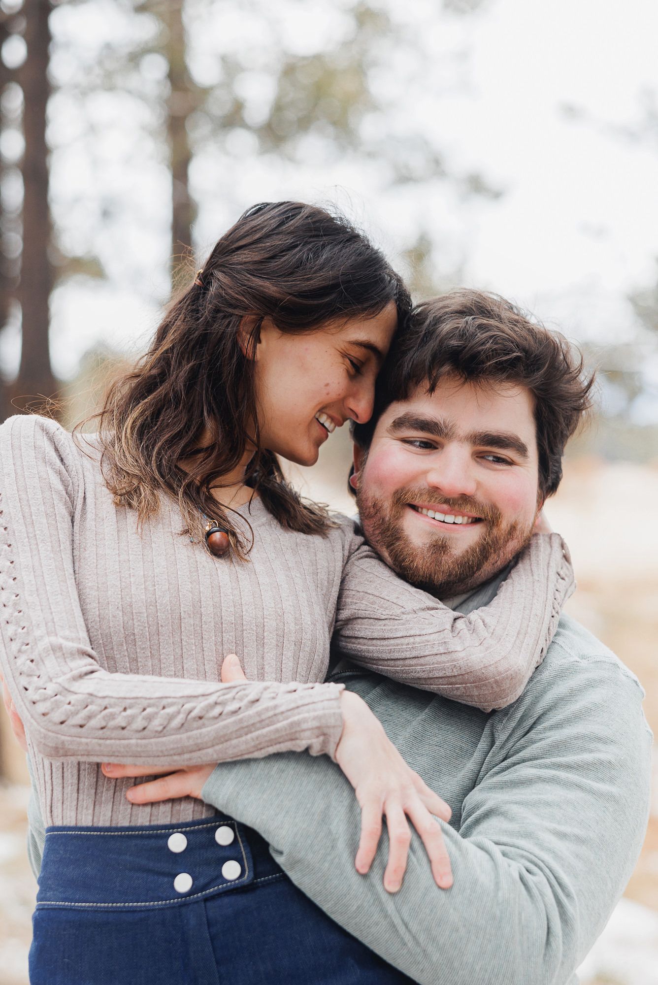 A couple in cozy sweaters share intimate moments in a series of three romantic outdoor photos.