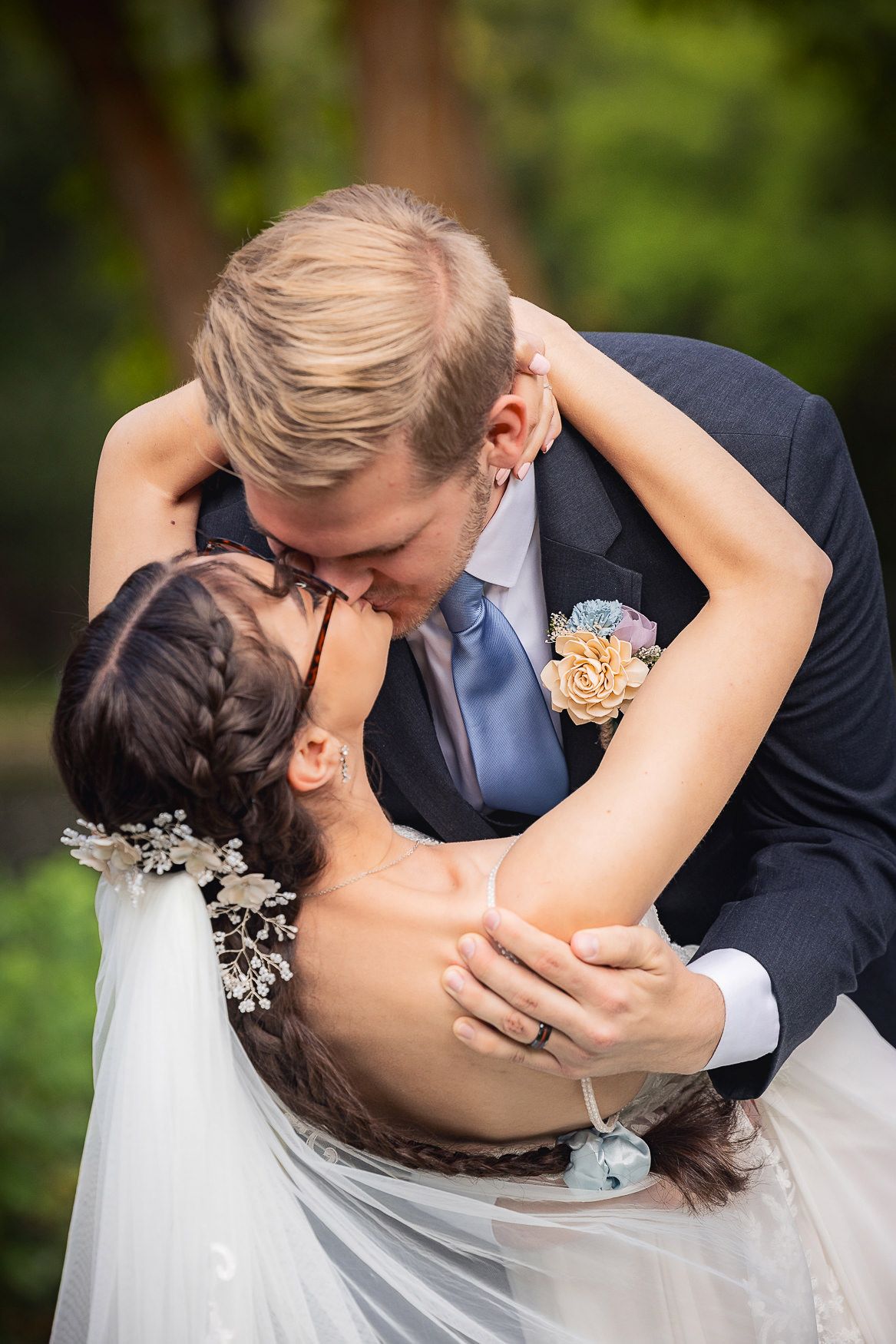 A romantic dip kiss moment captured during a wedding ceremony.