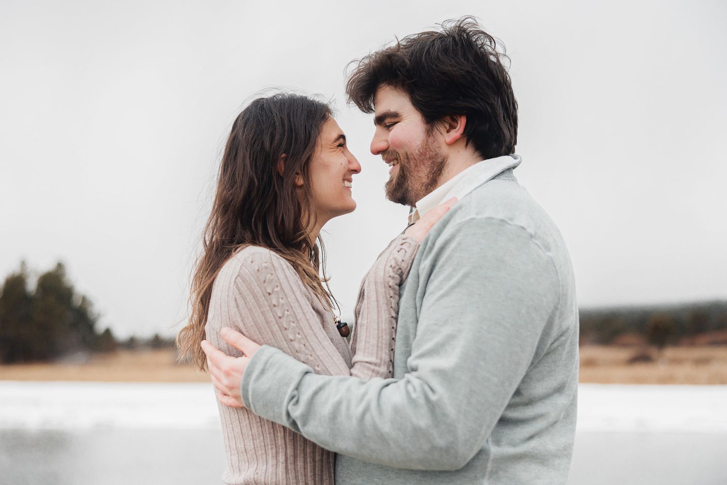 Romantic couple in casual winter outfits laughing and embracing outdoors in a series of candid moments.