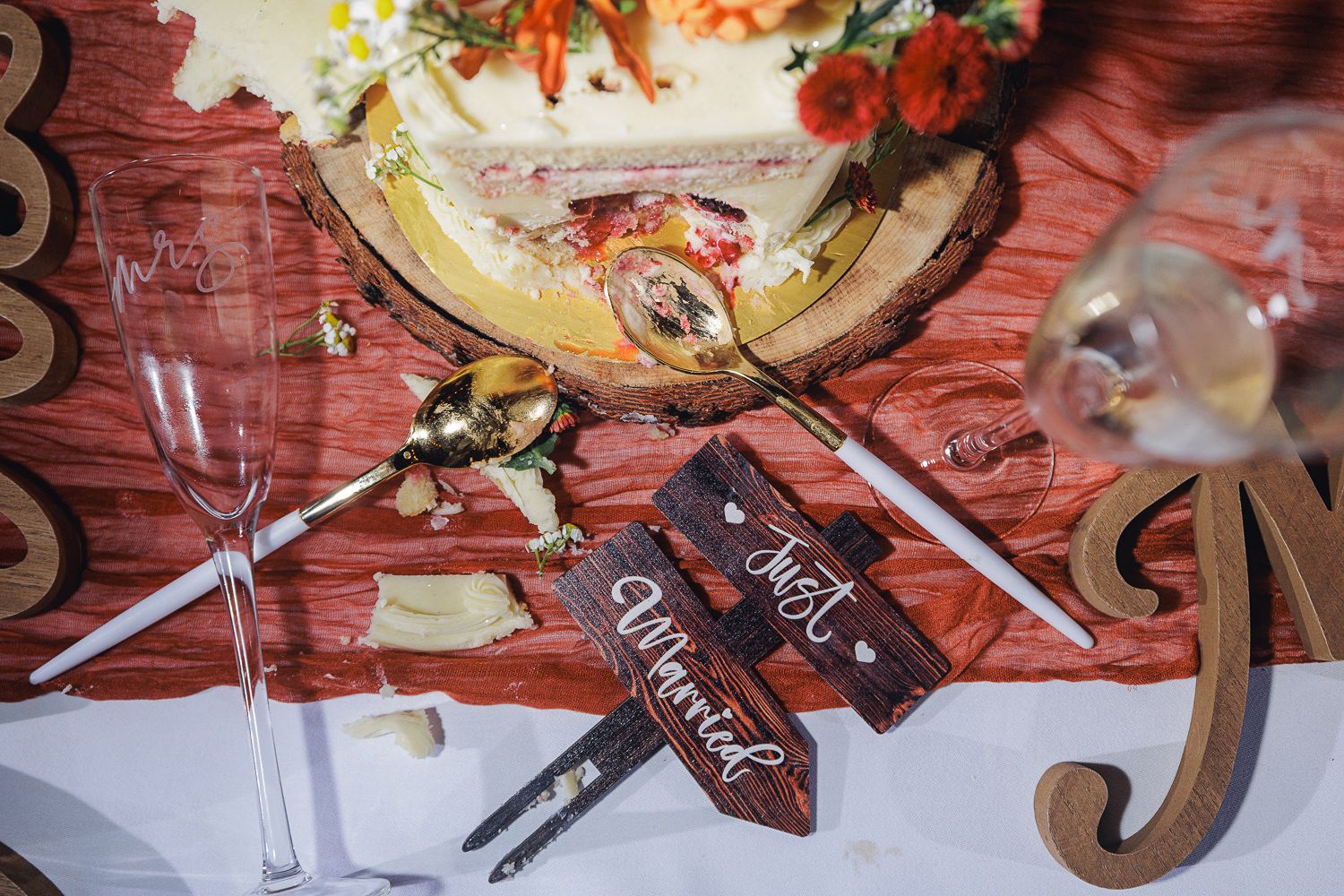 Wedding reception table details with rustic fall decorations and place settings.