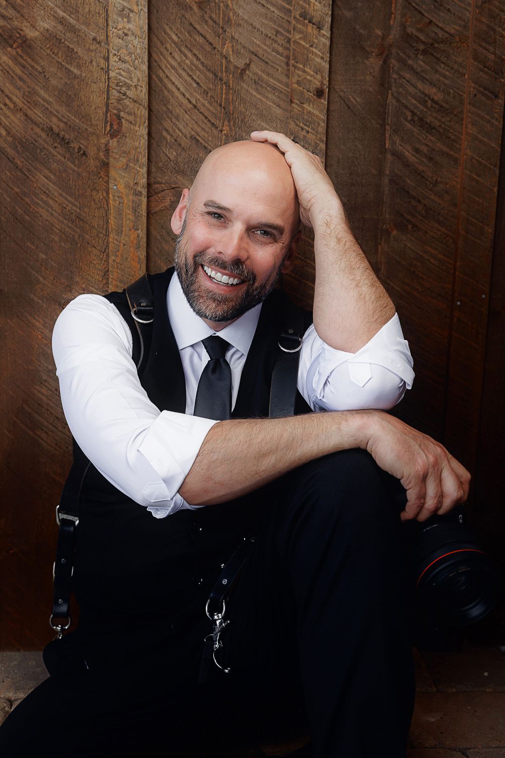 Professional headshot series showing a person in business attire against a dark wood background in various relaxed poses.