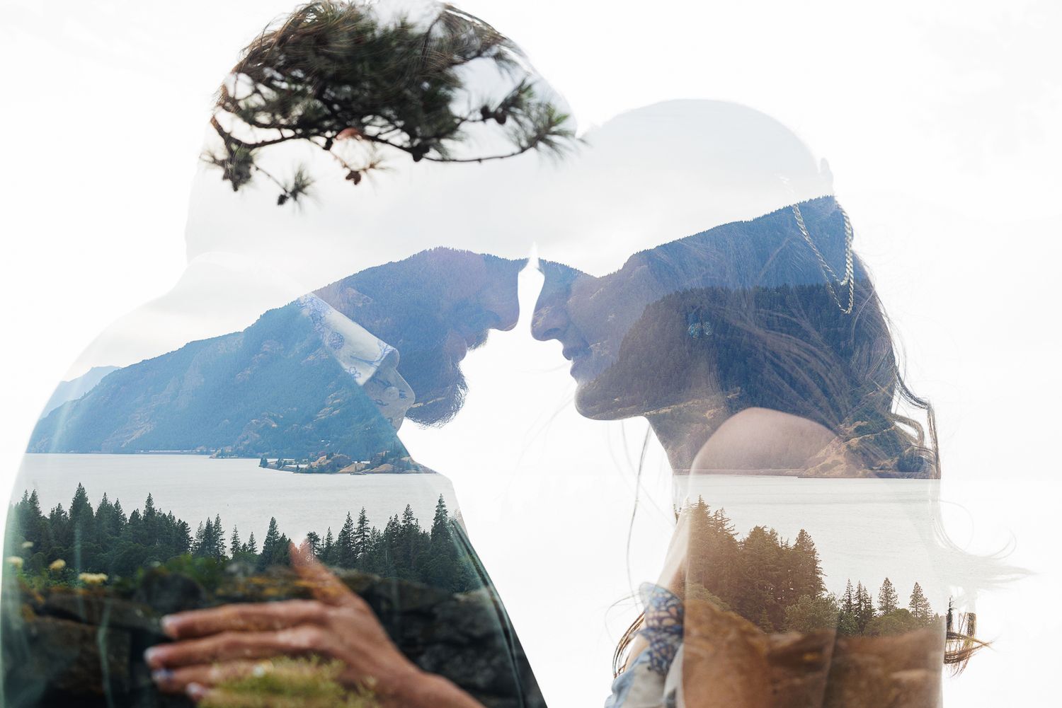 Double exposure photo of a romantic couple facing each other, blended with a scenic mountain and forest landscape.