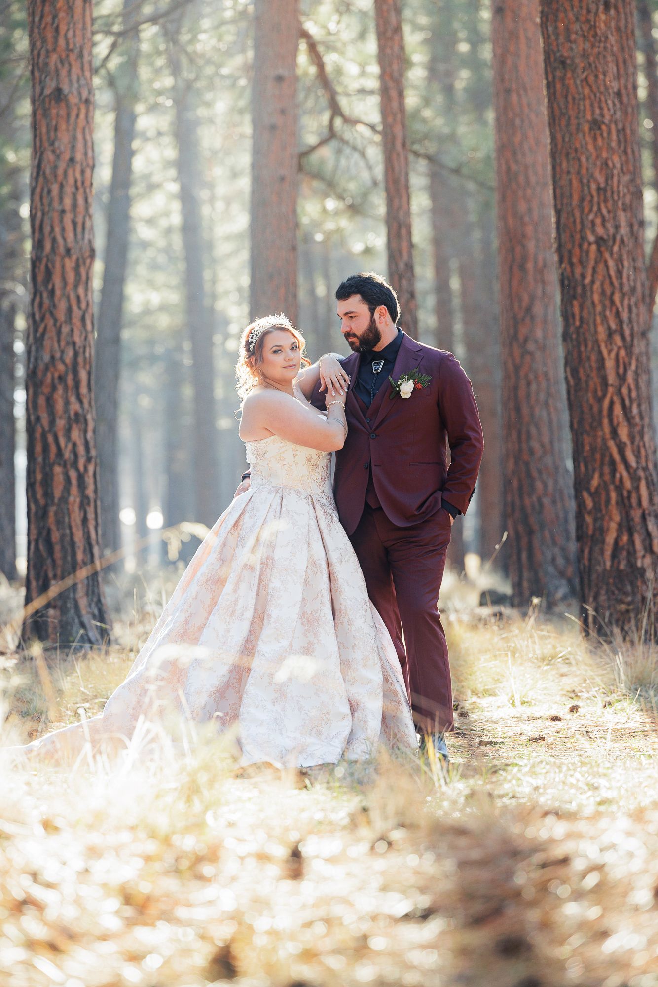 A romantic wedding photo sequence in a sunlit pine forest with autumn leaves on the ground.