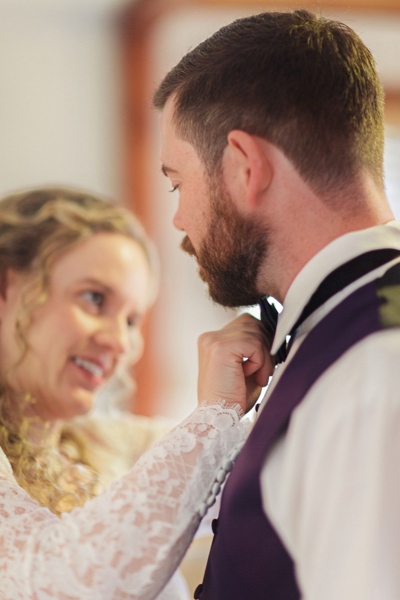 A couple in wedding attire share an intimate moment in a sequence of candid photos showing their joyful interaction.