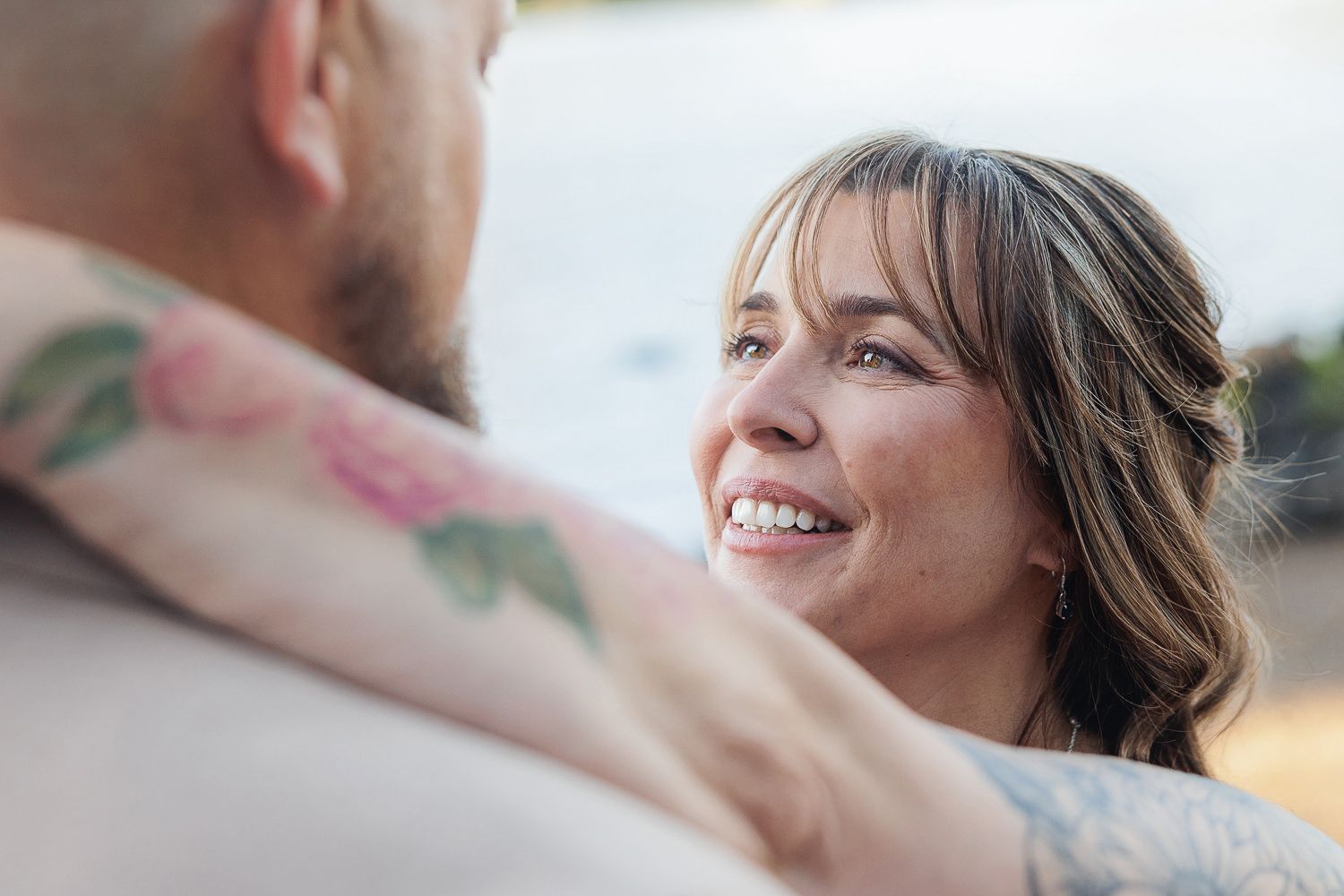 A series of candid moments between a couple during a warm intimate photoshoot outdoors.
