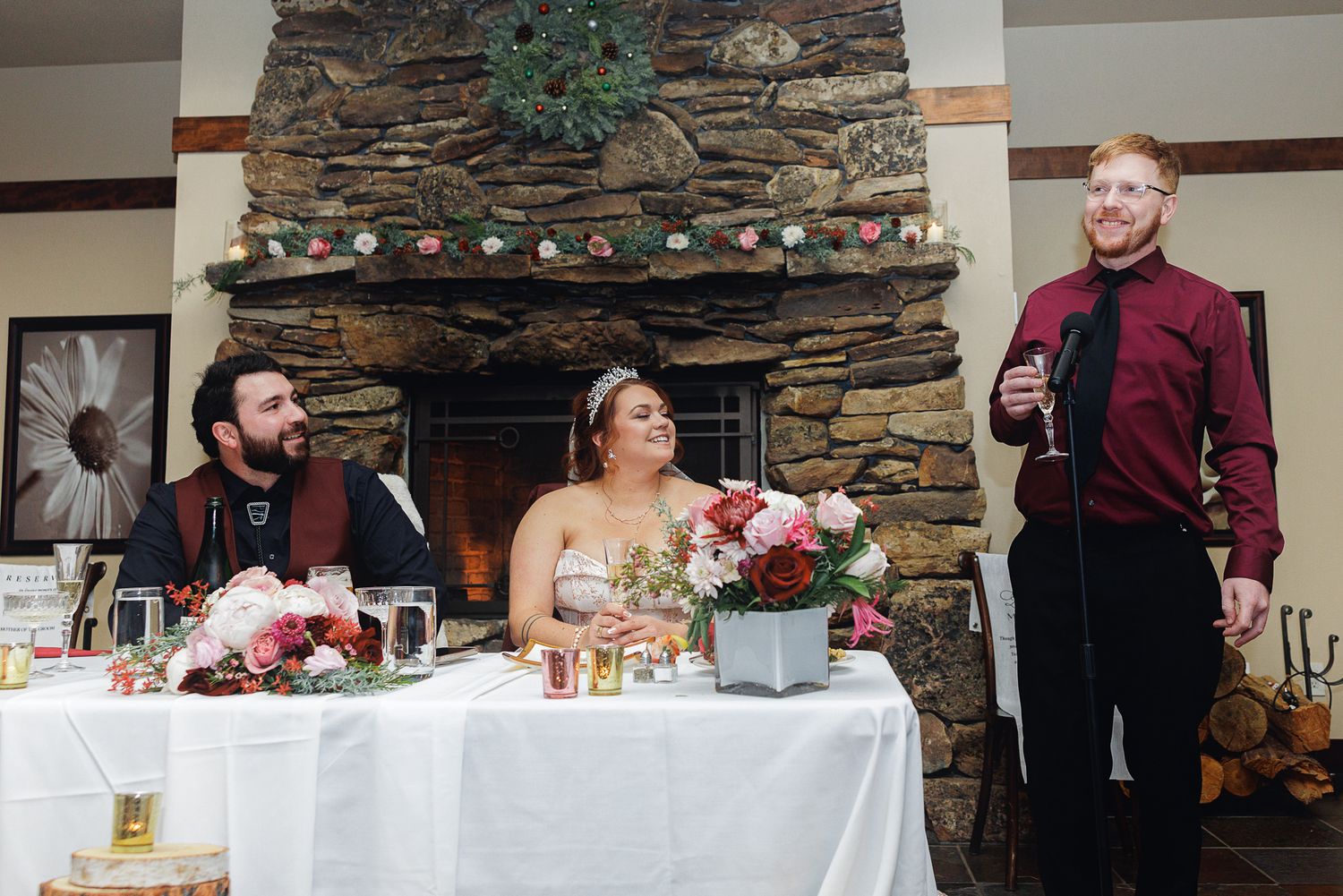 Wedding reception venue with stone walls and decorated white tables set for a celebration.