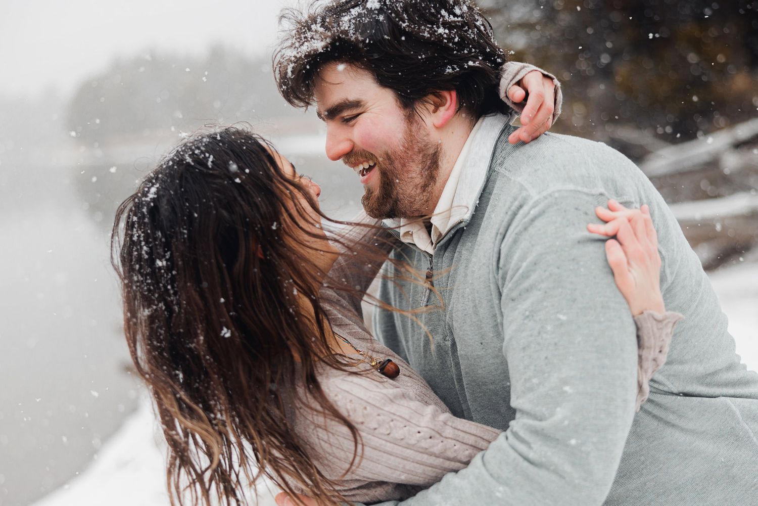 A romantic couple shares tender moments in a series of black and white photographs during a winter photoshoot.
