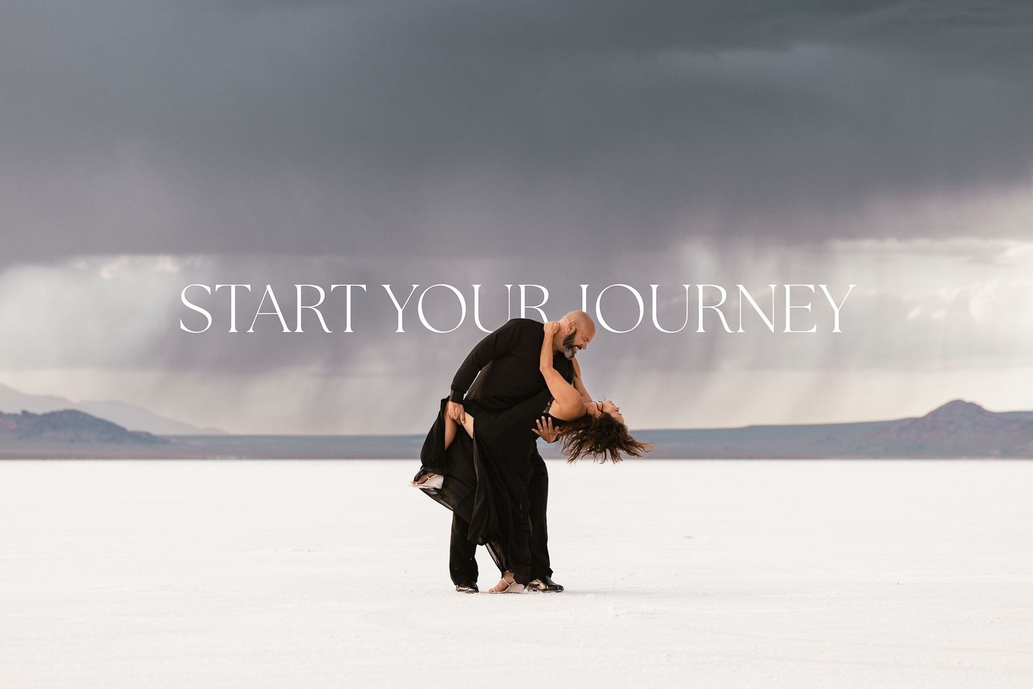 Two silhouettes stand in dramatic lighting on salt flats with 'Start Your Journey' text overlay.