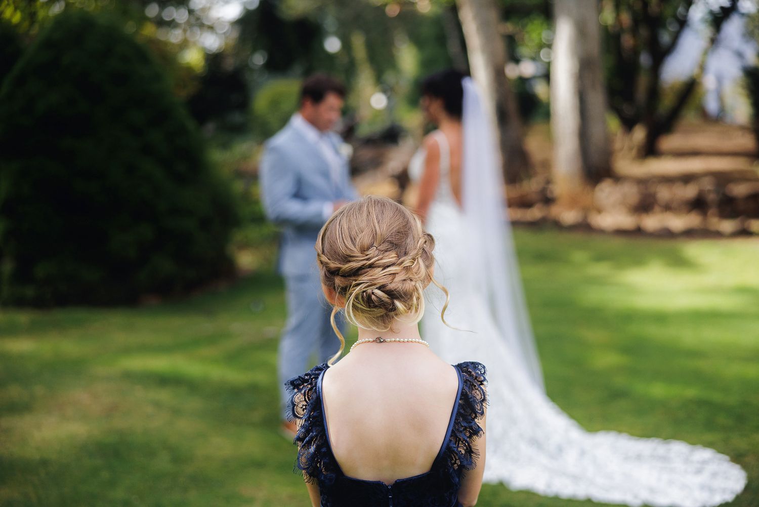 Wedding couple embraces in a romantic garden setting during golden hour photography session.