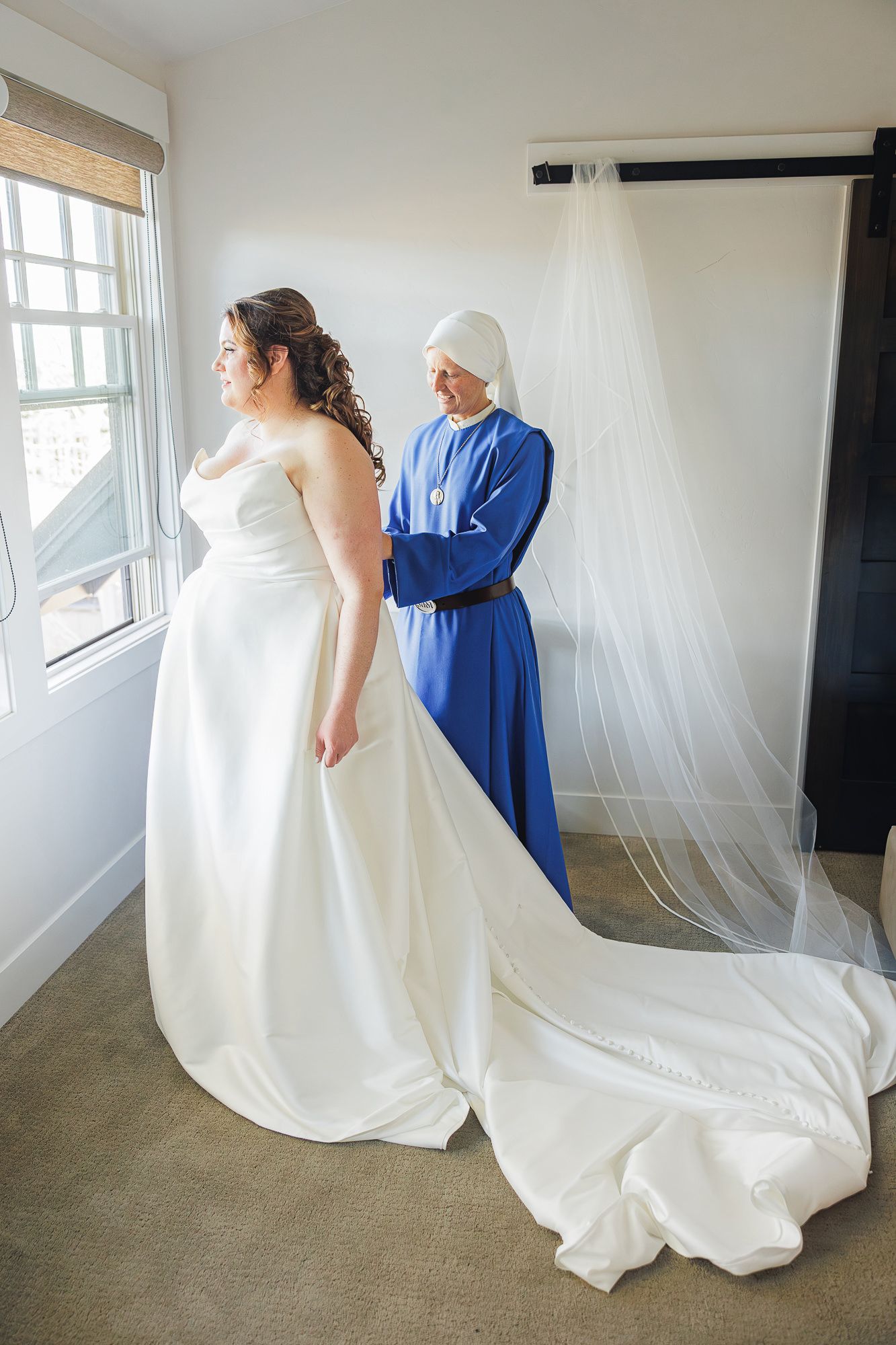 A sequence of photos showing a flowing white wedding dress being adjusted and arranged against a bright window backdrop.