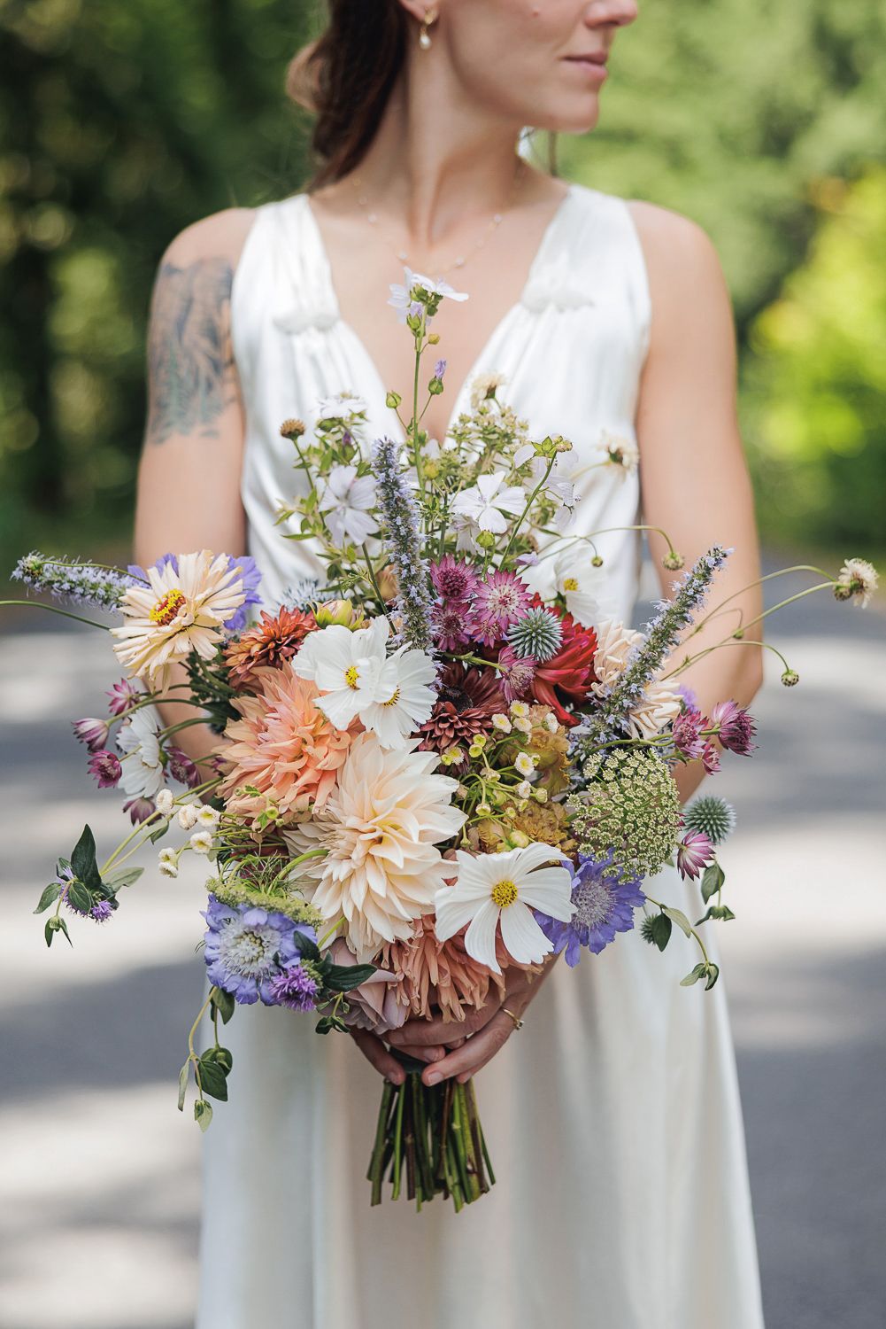 A series of colorful bridal bouquets featuring dahlias, wildflowers and mixed blooms against a soft outdoor background.