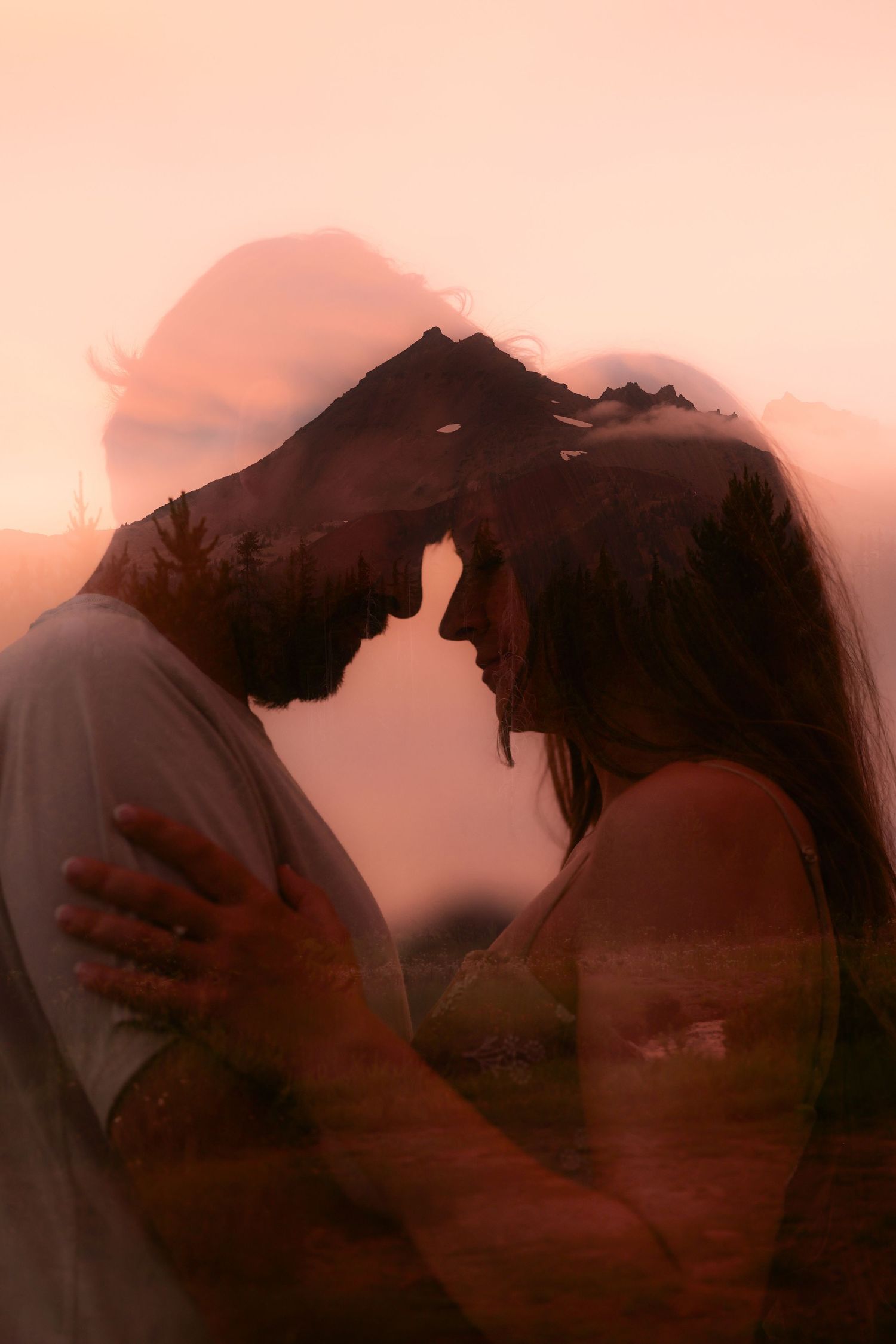 Silhouettes of a romantic couple embrace against a pink sunset sky, creating a dreamy and intimate moment.