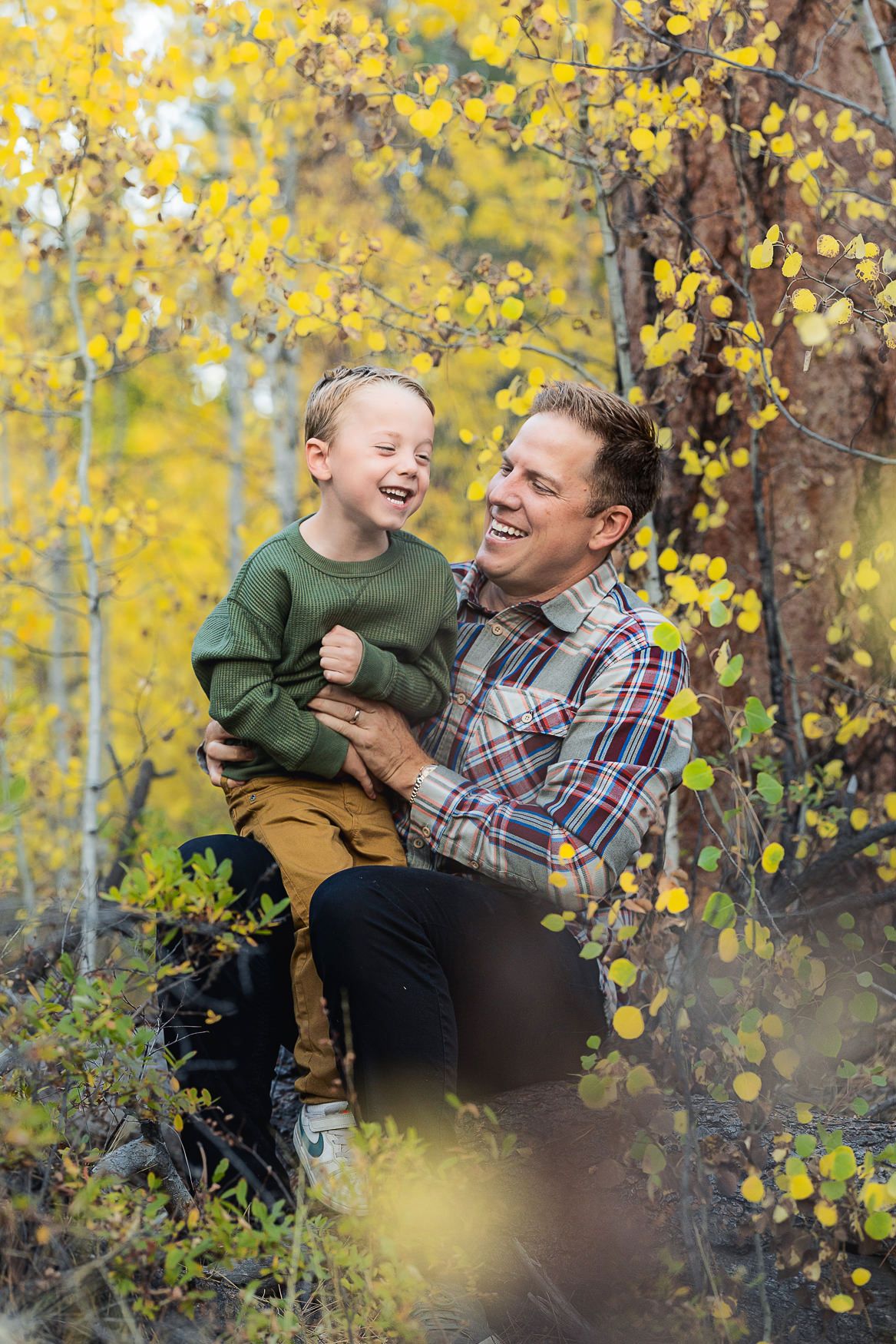 Joyful autumn moment captured among vibrant yellow aspen trees in nature.