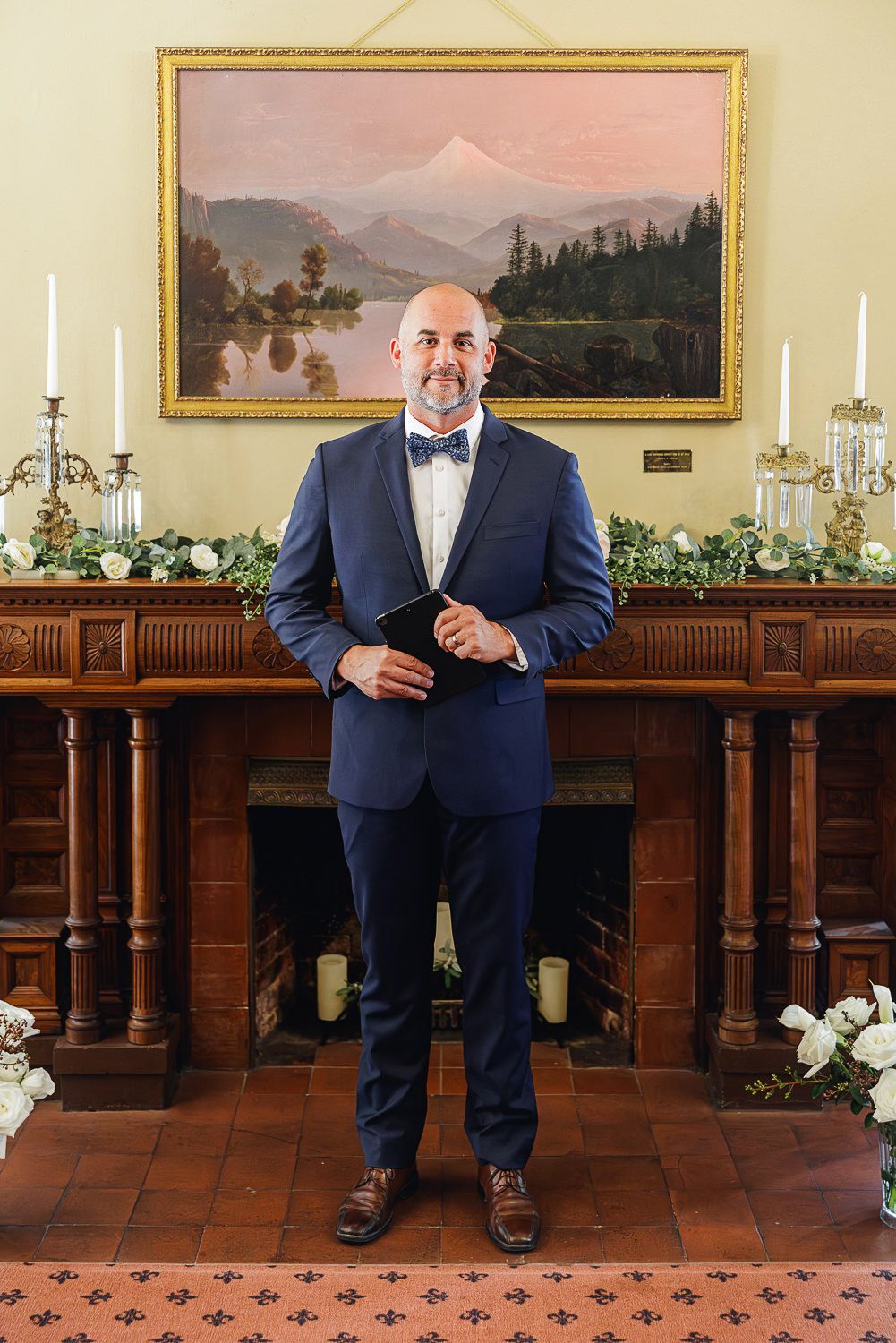 Artistic wedding photo collage showing framed shots of groom sitting on bench in navy suit with decor and paintings.