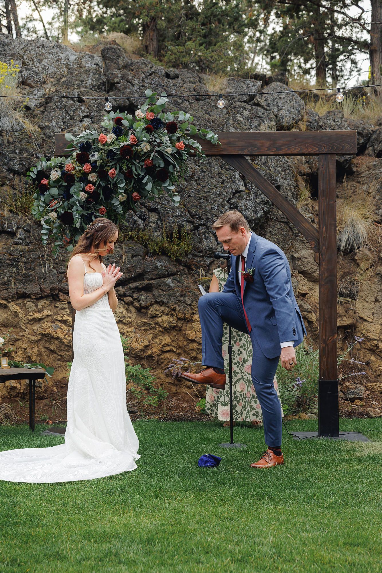 A sequence of photos showing a couple performing a romantic proposal on a grassy lawn with stone wall and floral backdrop.