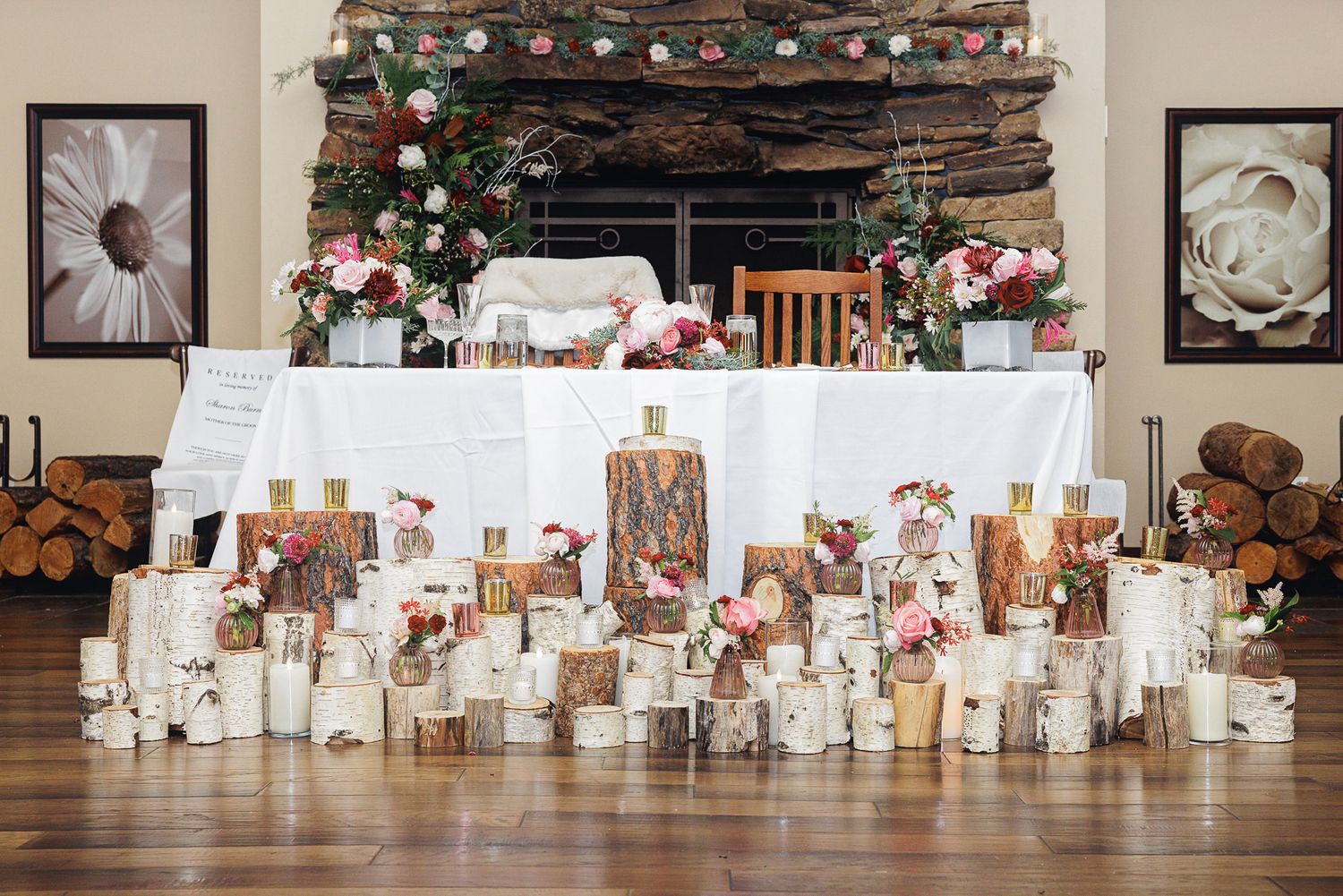 Elegant wedding reception setup with white tables and chairs arranged in rows inside a rustic venue with exposed beams.