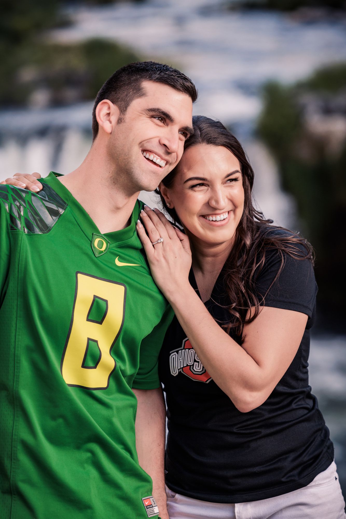 A couple in green and black attire share intimate moments in an outdoor photo series.