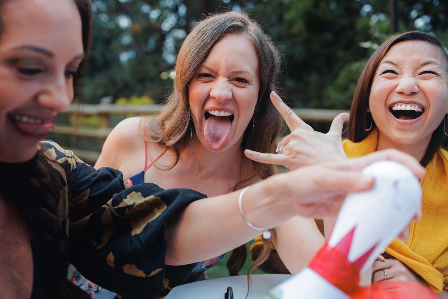 A series of candid photos showing people laughing and enjoying themselves at an outdoor event.