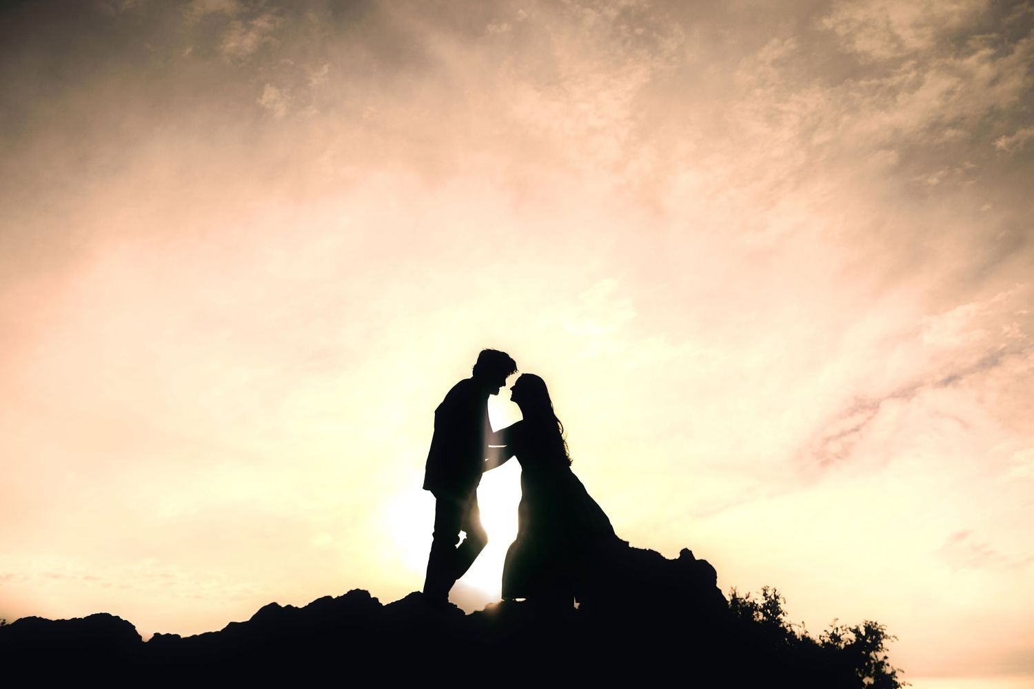 Dramatic silhouettes of people on mountaintops against a sunset sky create a series of stunning landscape photographs.