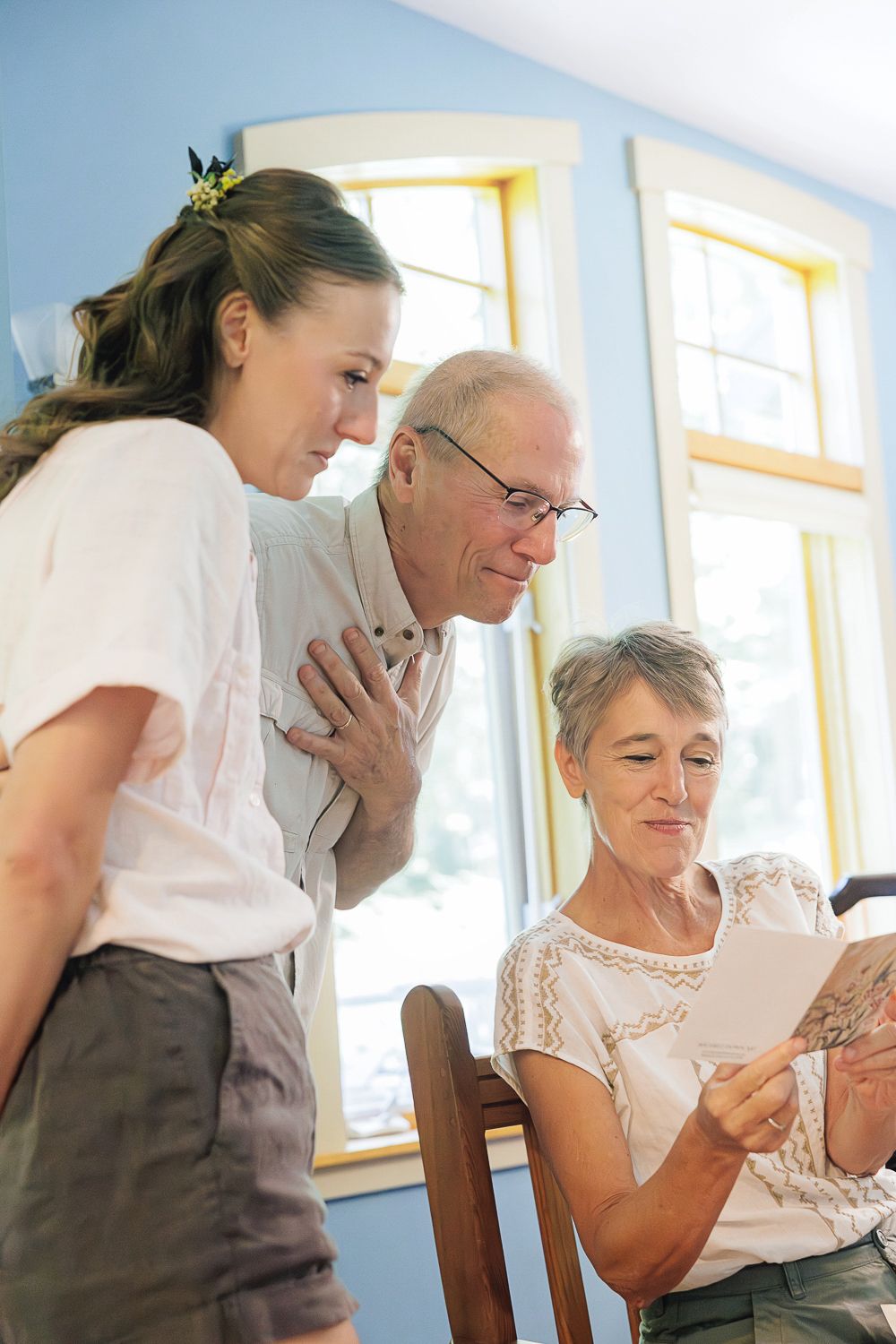 Healthcare worker providing compassionate support to elderly patient in a sunlit medical facility.
