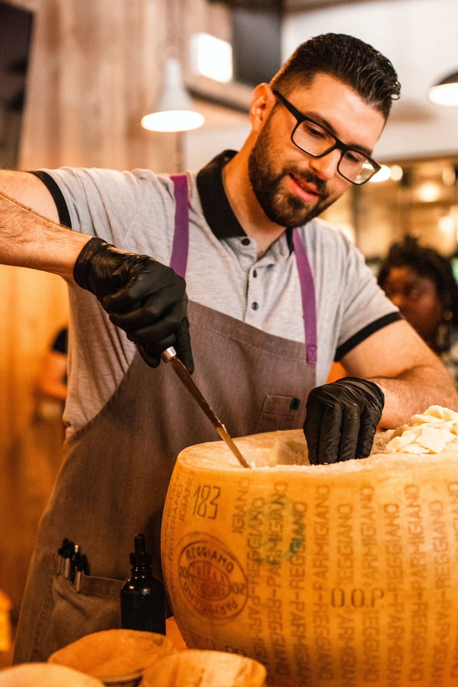 Denver food photographer and Denver social media manager, a man cutting cheese