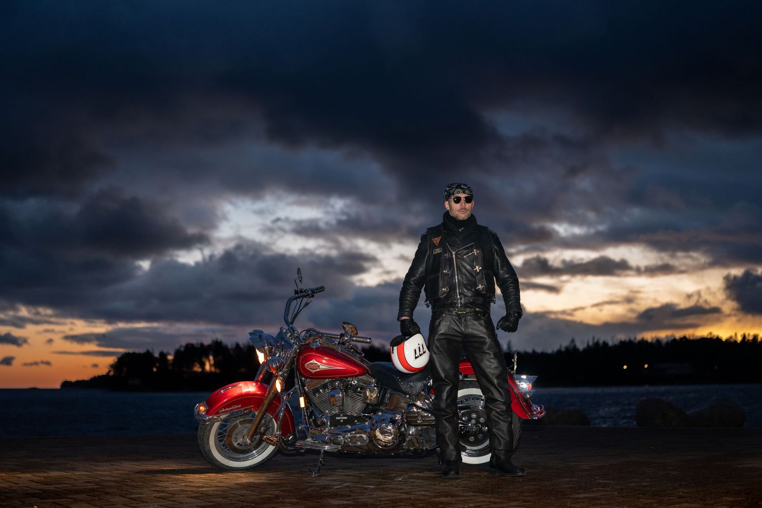 A series of motorcycle silhouettes against dramatic sunset skies with stormy clouds and vibrant colors.