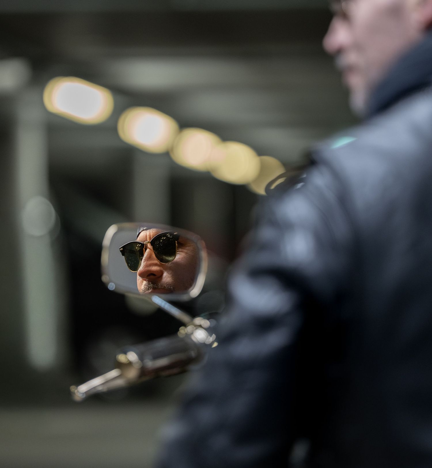 A series of blurred photos showing hands holding and lighting a cigar in low light conditions.