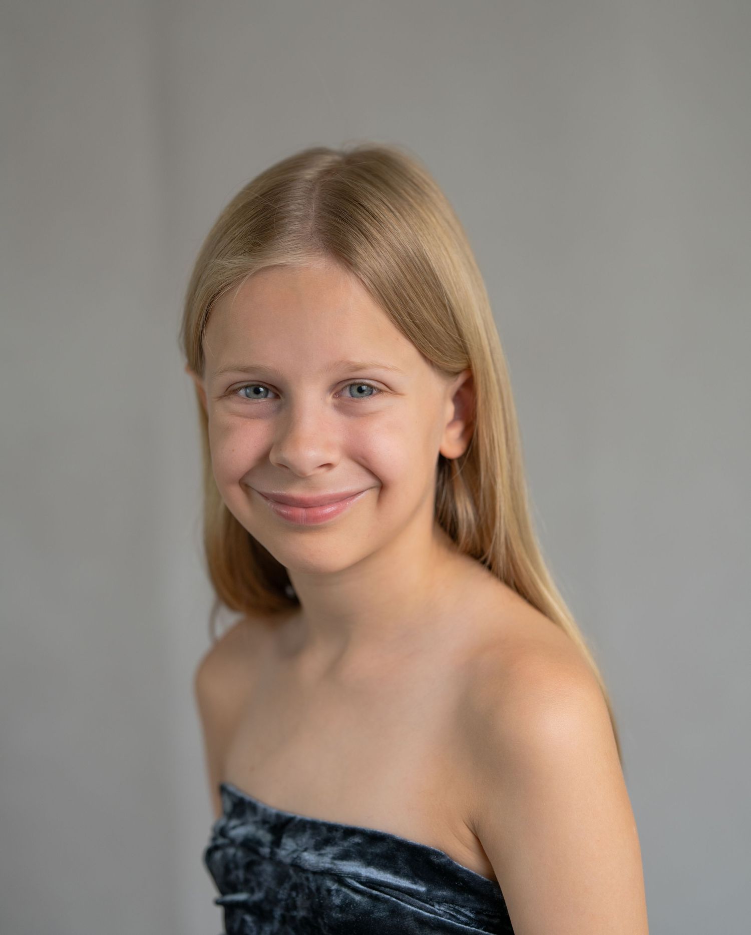 A series of four similar photos showing someone with blonde hair wearing a black strapless top against a neutral background.