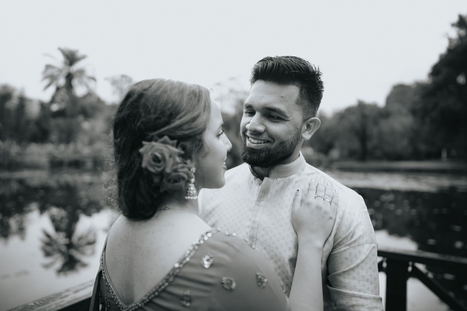 Black and white intimate portrait of couple sharing romantic moment outdoors.