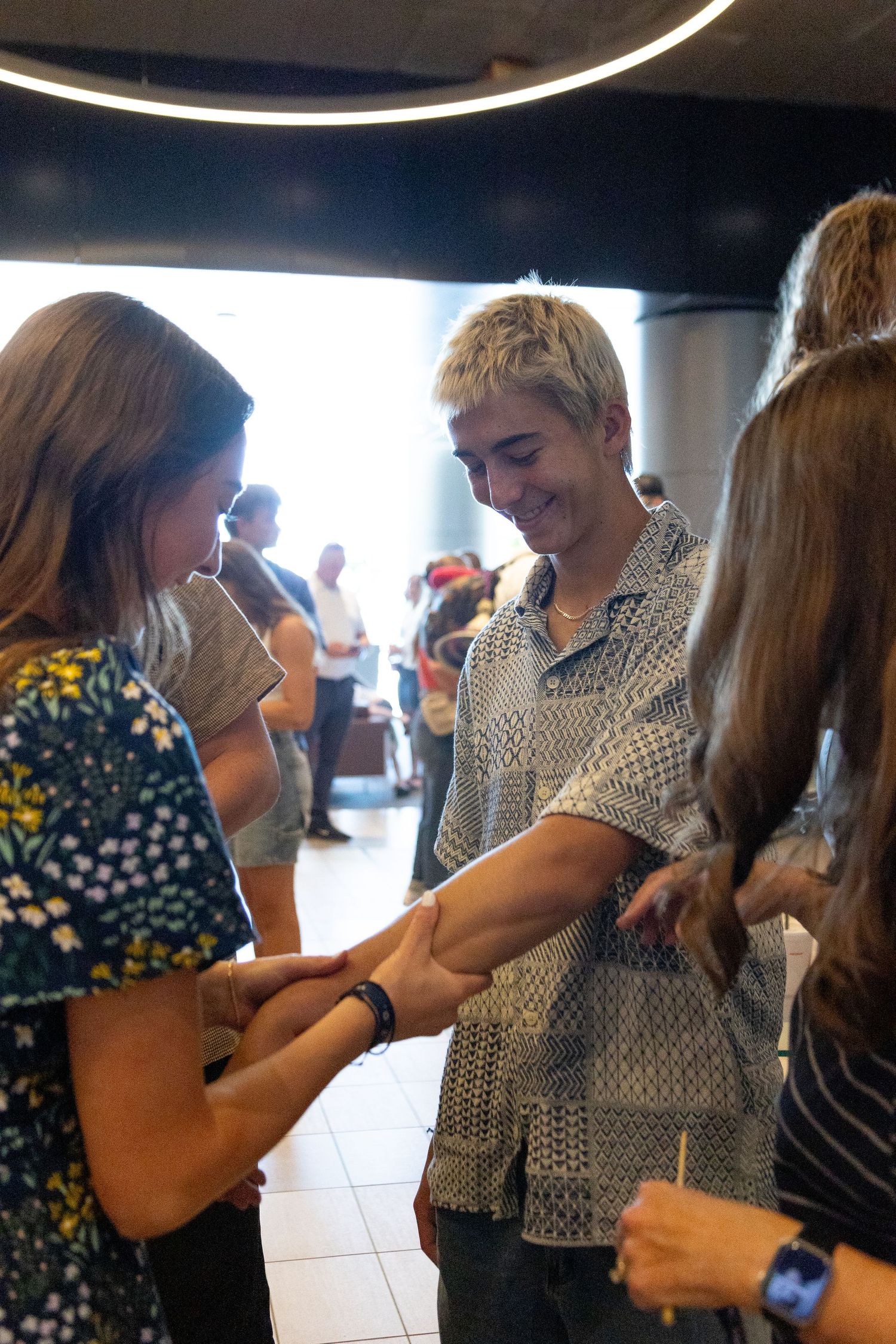 Sibling and return missionary have fun together at the Salt Lake airport.