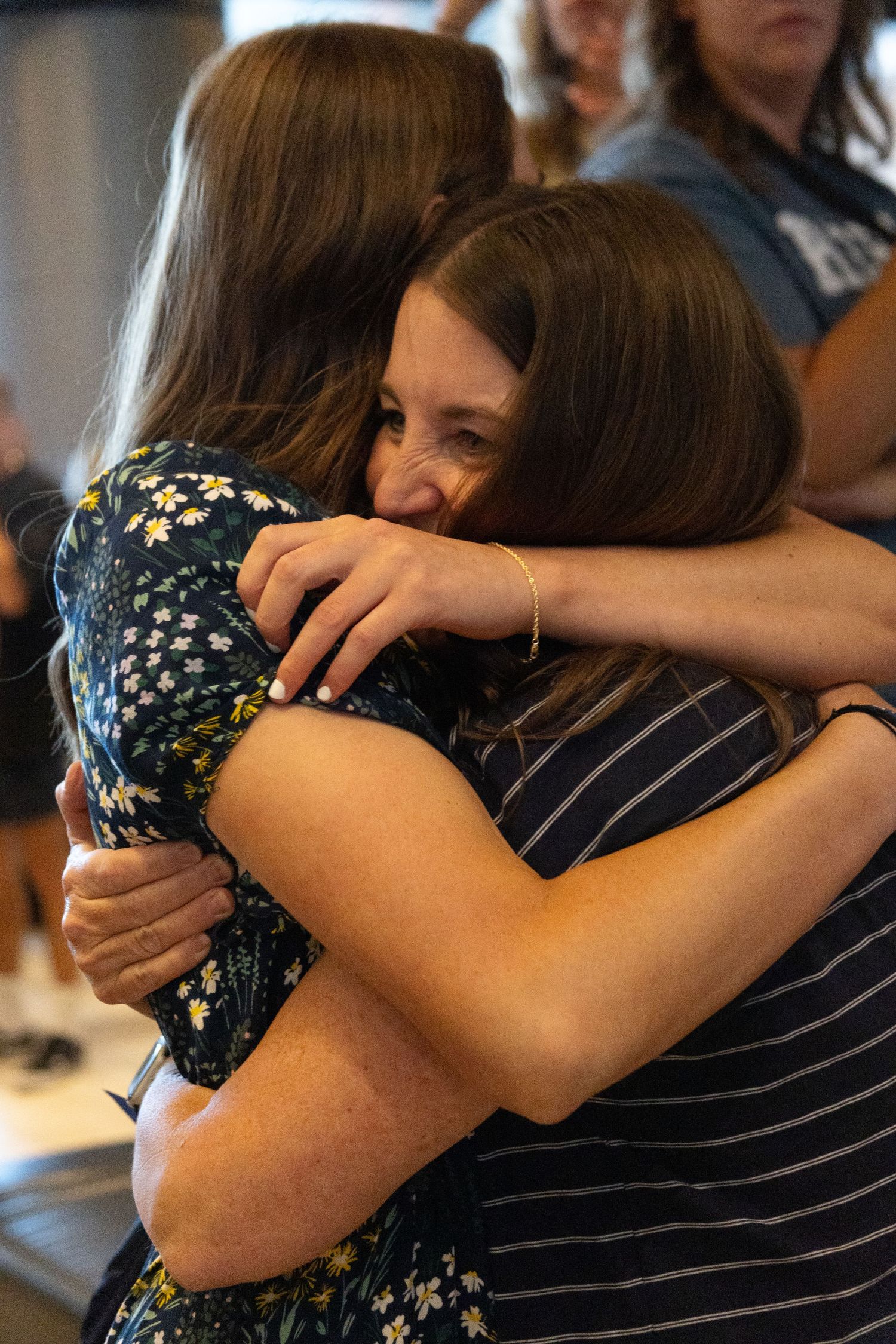 Mom and return missionary daughter share a joyful embrace at an airport reunion at the Salt Lake airport.