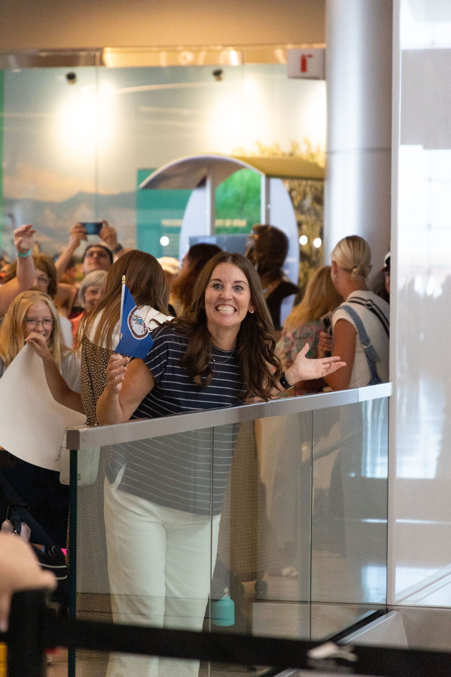 Mom in airport is excited to greet her returned missionary daughter in the Salt Lake airport.