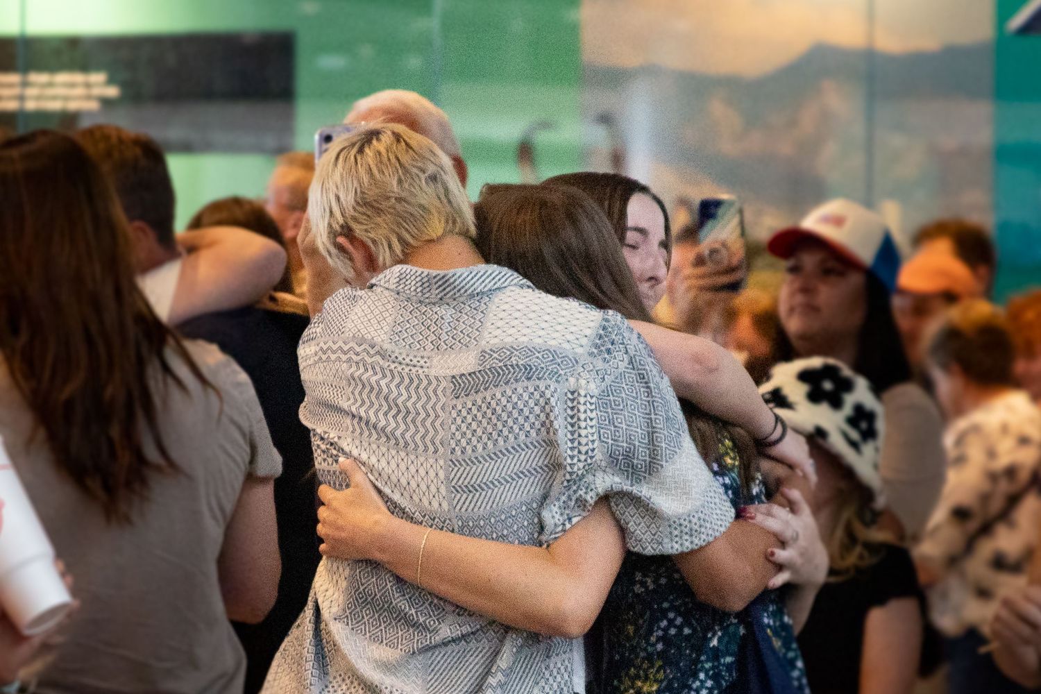Siblings reunite with their return missionary sister in the Salt Lake Airport.