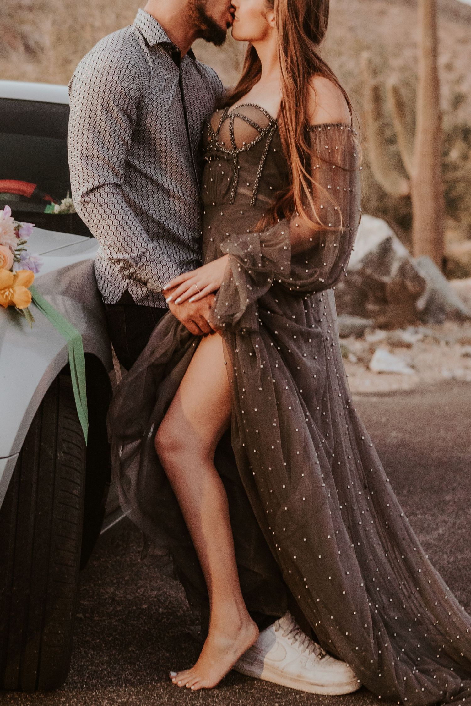 Romantic scene by car with sparkly dress and intimate poses.