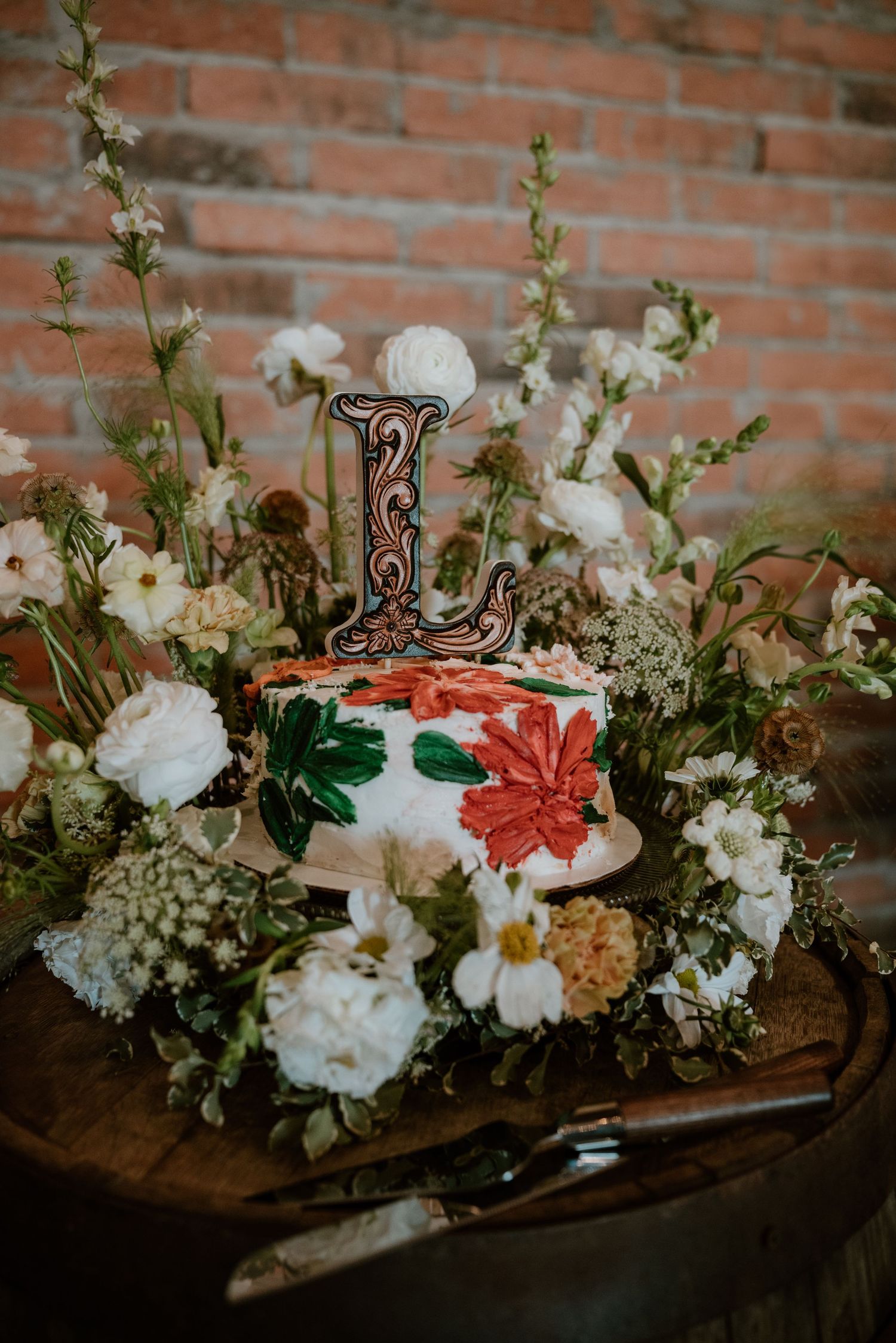 Elegant floral centerpiece with white and coral blooms in rustic wooden container.