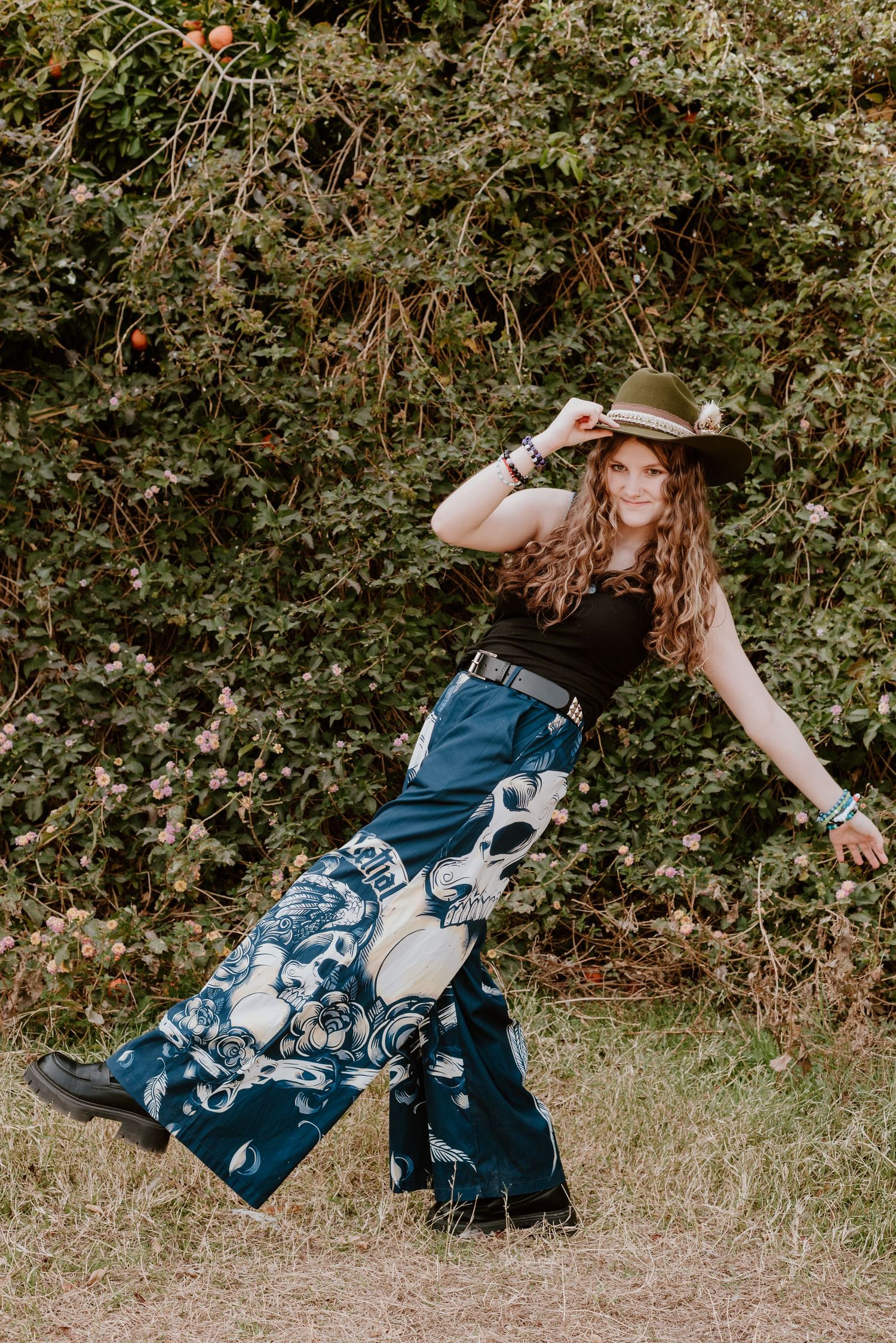 Dynamic movement shot of blue patterned dress flowing in outdoor setting with greenery.