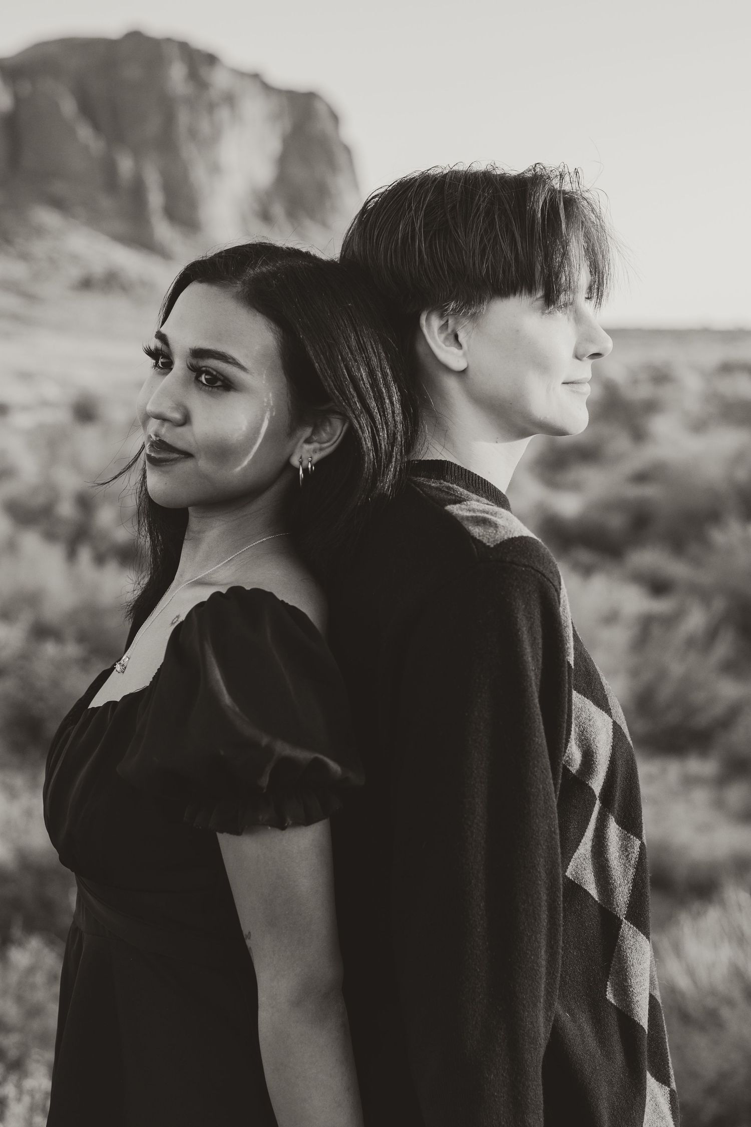 Artistic black and white portraits of a couple in a desert setting.