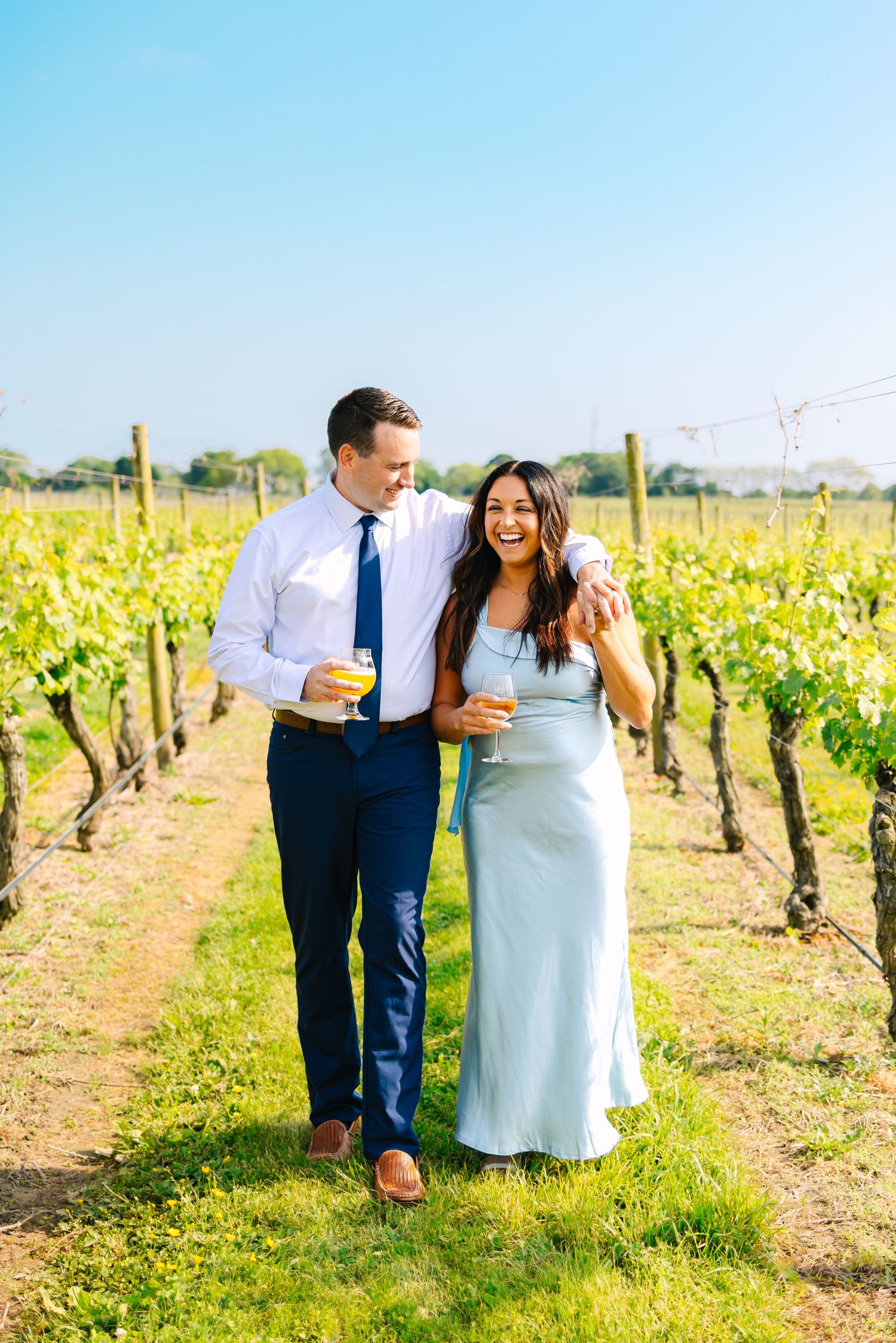 Newly engaged couple taking engagement portraits at Newport Vineyards wedding venue in Newport, Rhode Island