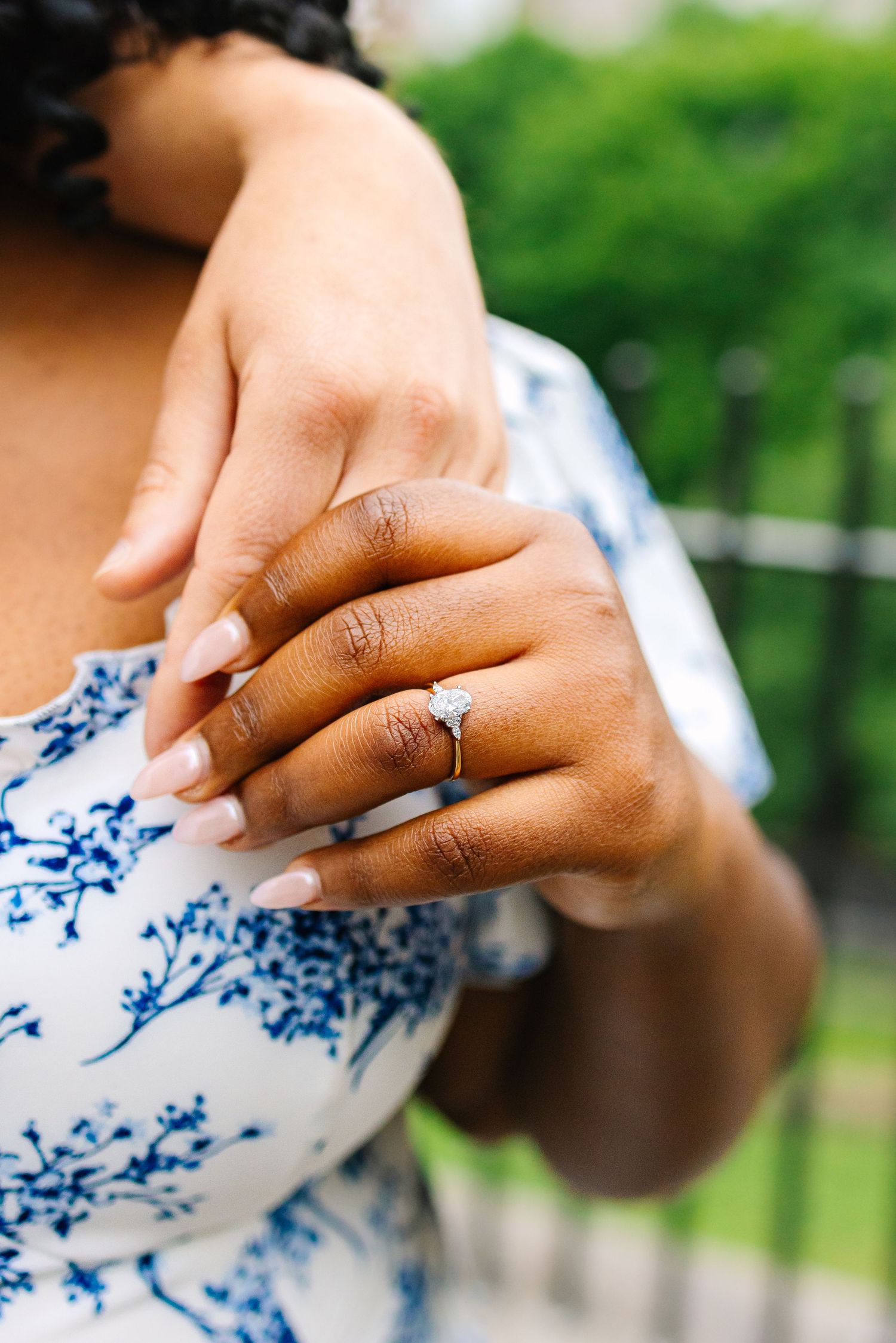 Close-up of hands wearing an engagement ring during engagement photos in Providence Rhode Island