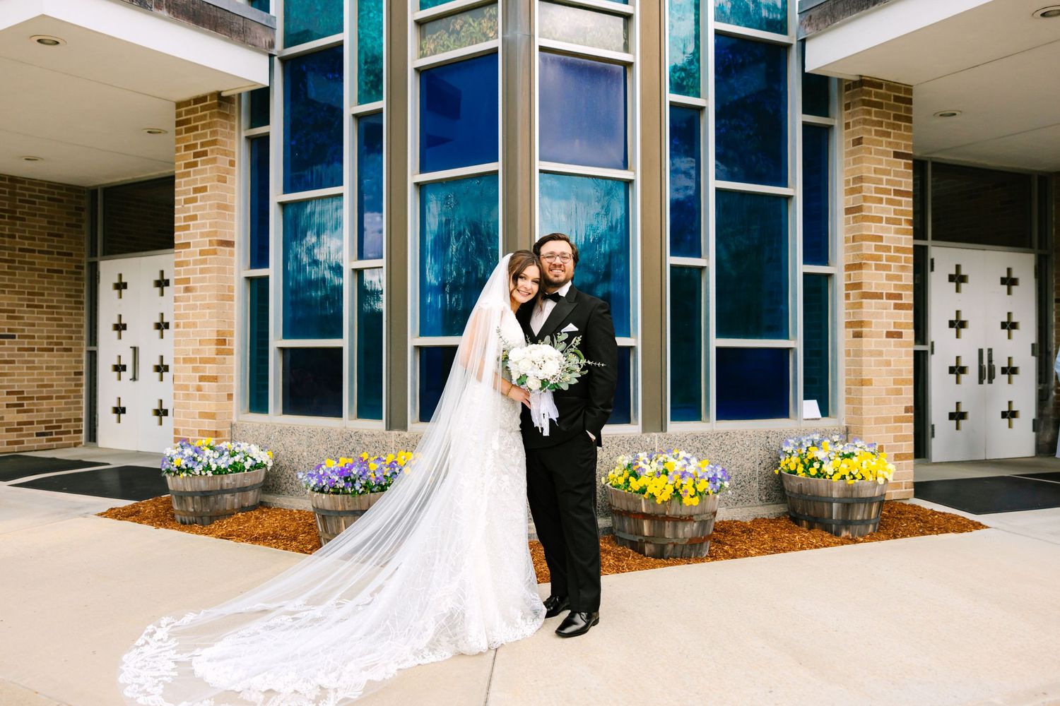 A bride and groom pose for couples portraits outside of wedding venue in Boston Massachusetts