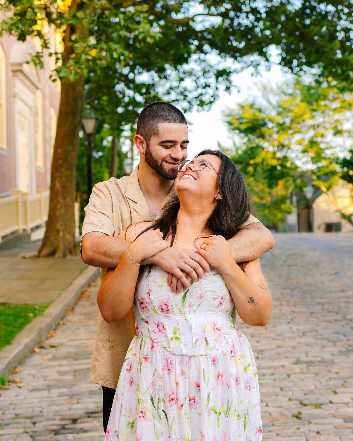Romantic couple embracing on a cobblestone street for engagement photos in Downtown New Bedford Massachusetts