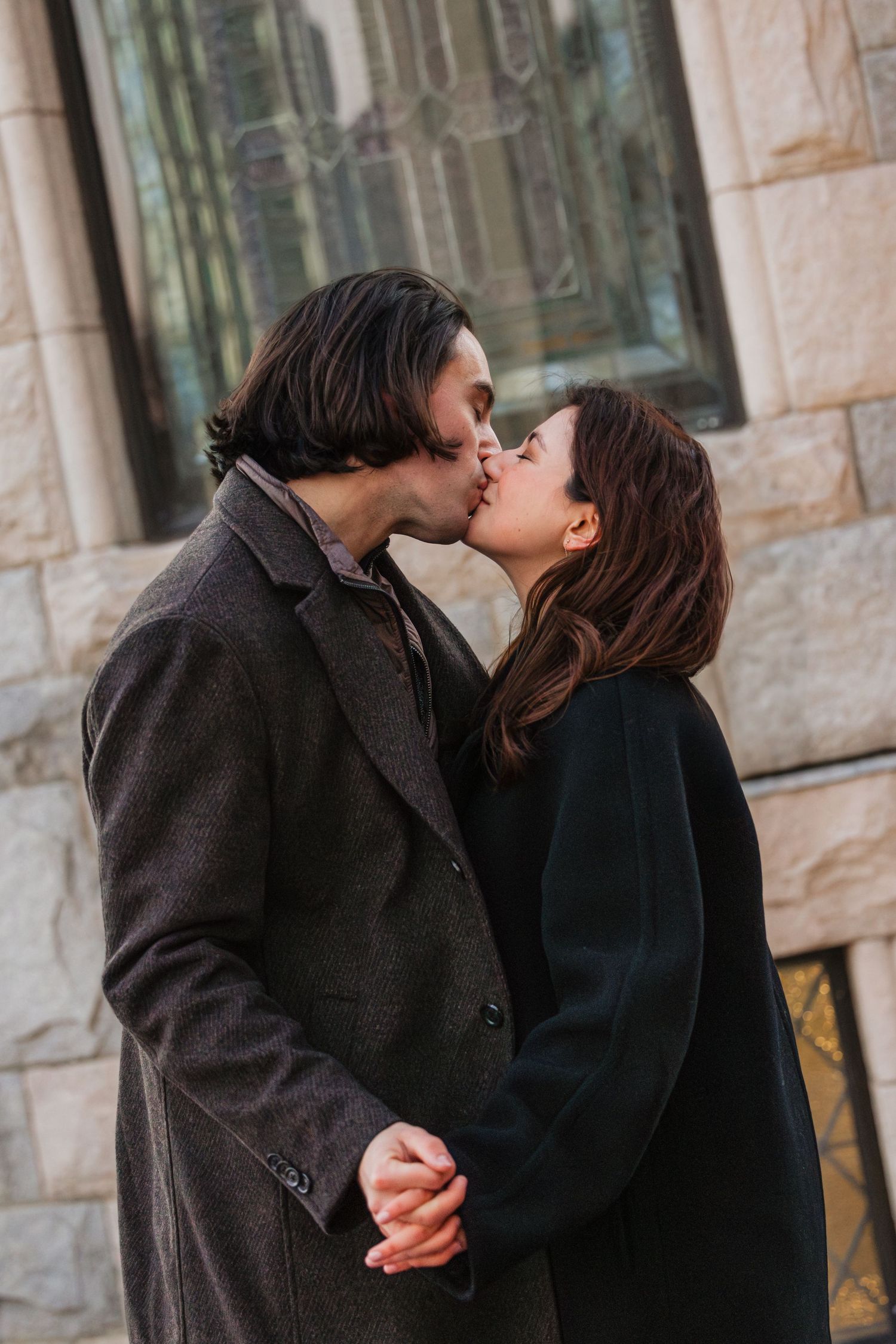 A romantic winter kiss at the Christian Science Museum in Boston Massachusetts