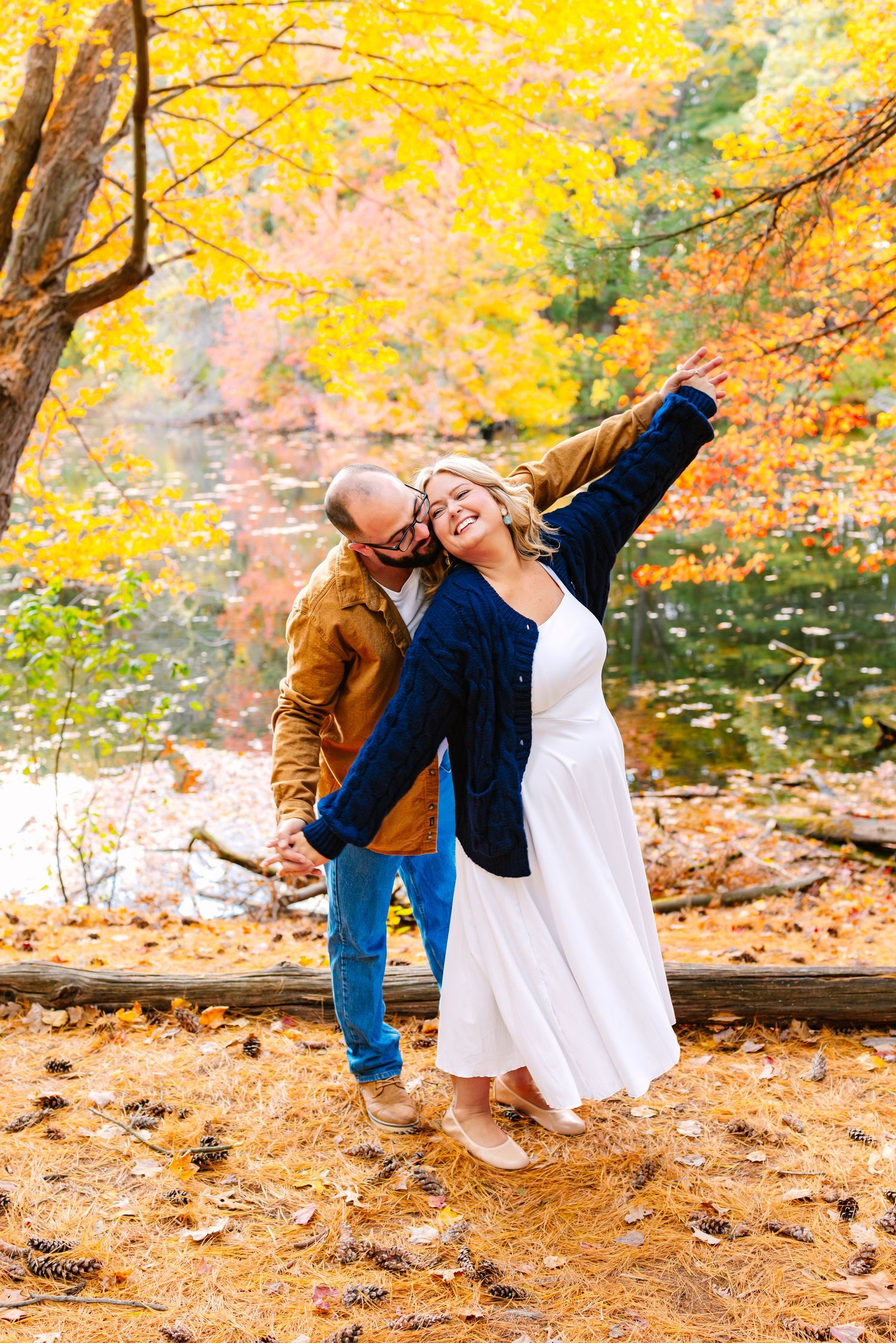 A romantic autumn engagement session of couples posing candidly at Goddard Memorial State Park in Warwick, Rhode Island