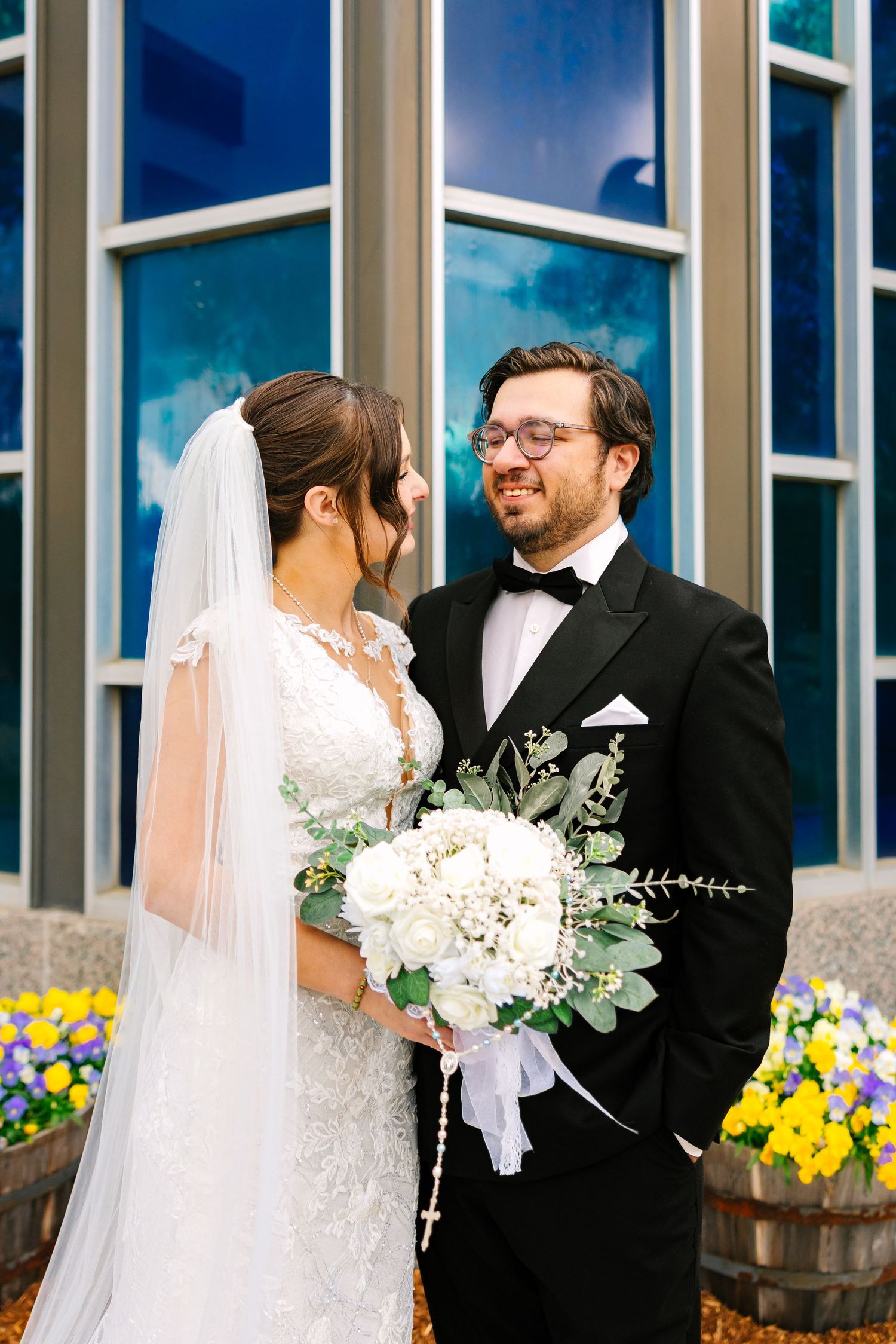 Bride and groom share a loving moment outside a modern ceremony wedding venue for couples portraits in Boston Massachusetts